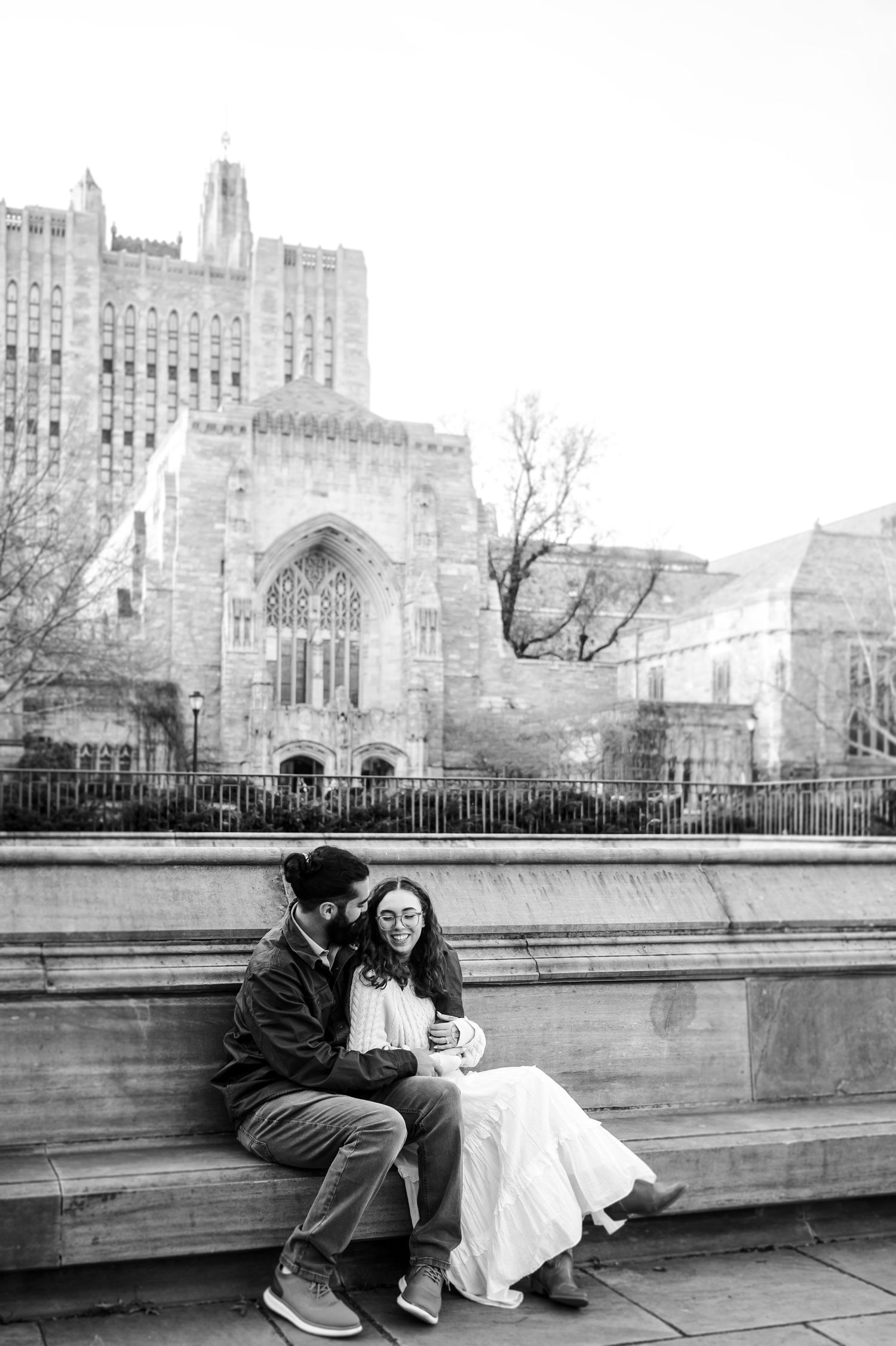 Black and white photos of a couple sitting together against a Gothic architectural backdrop.