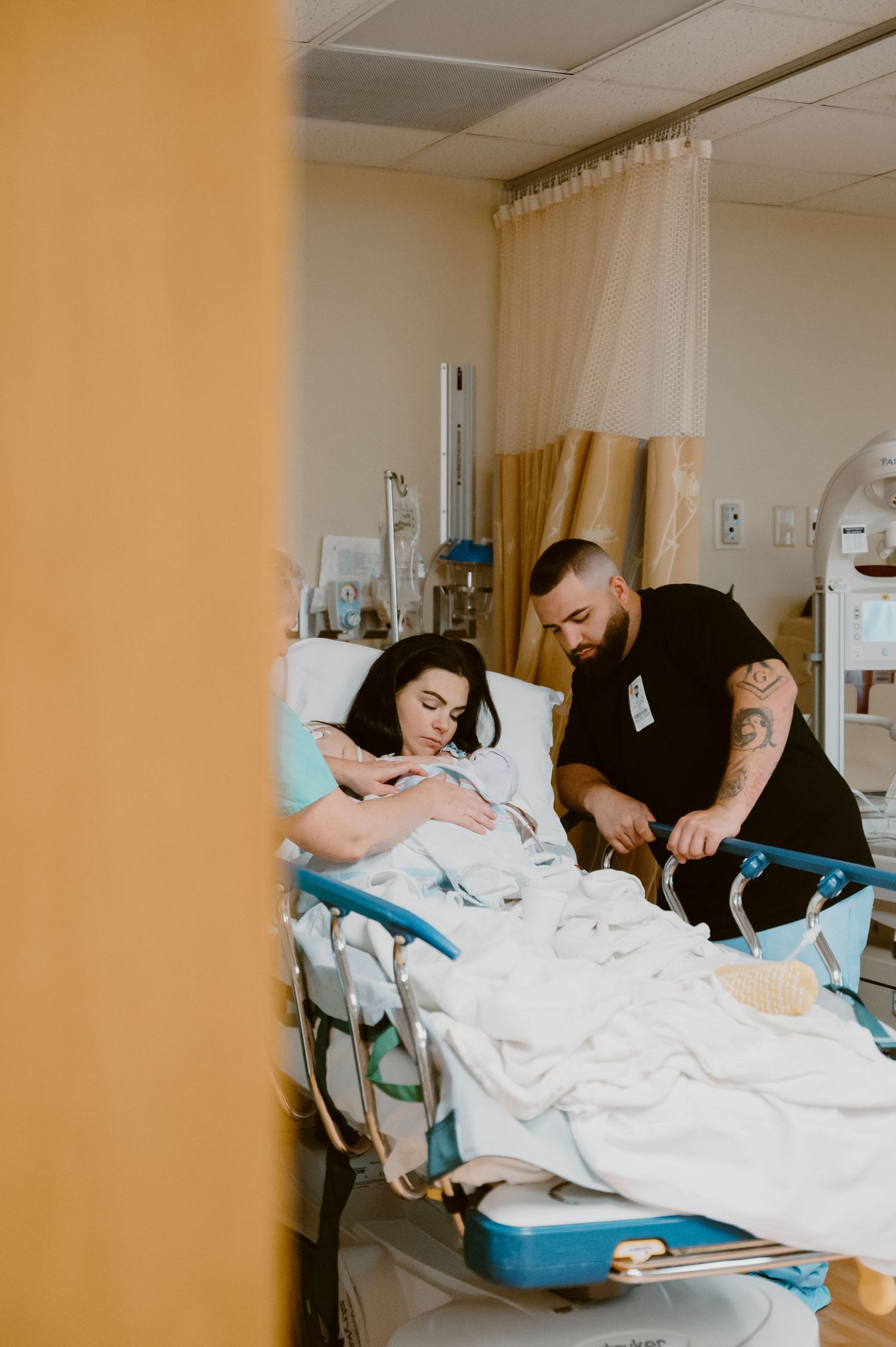 Tender moment captured in hospital room during labor and delivery.