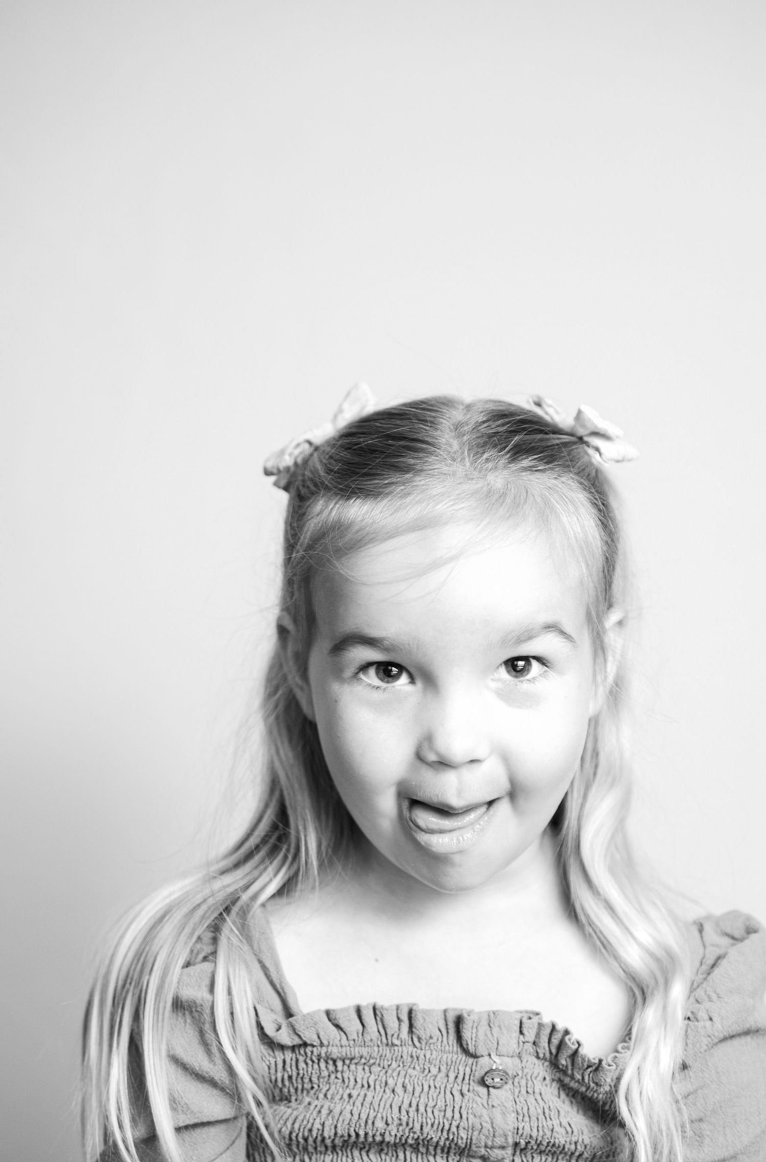 Black and white portrait sequence capturing playful expressions and movement.