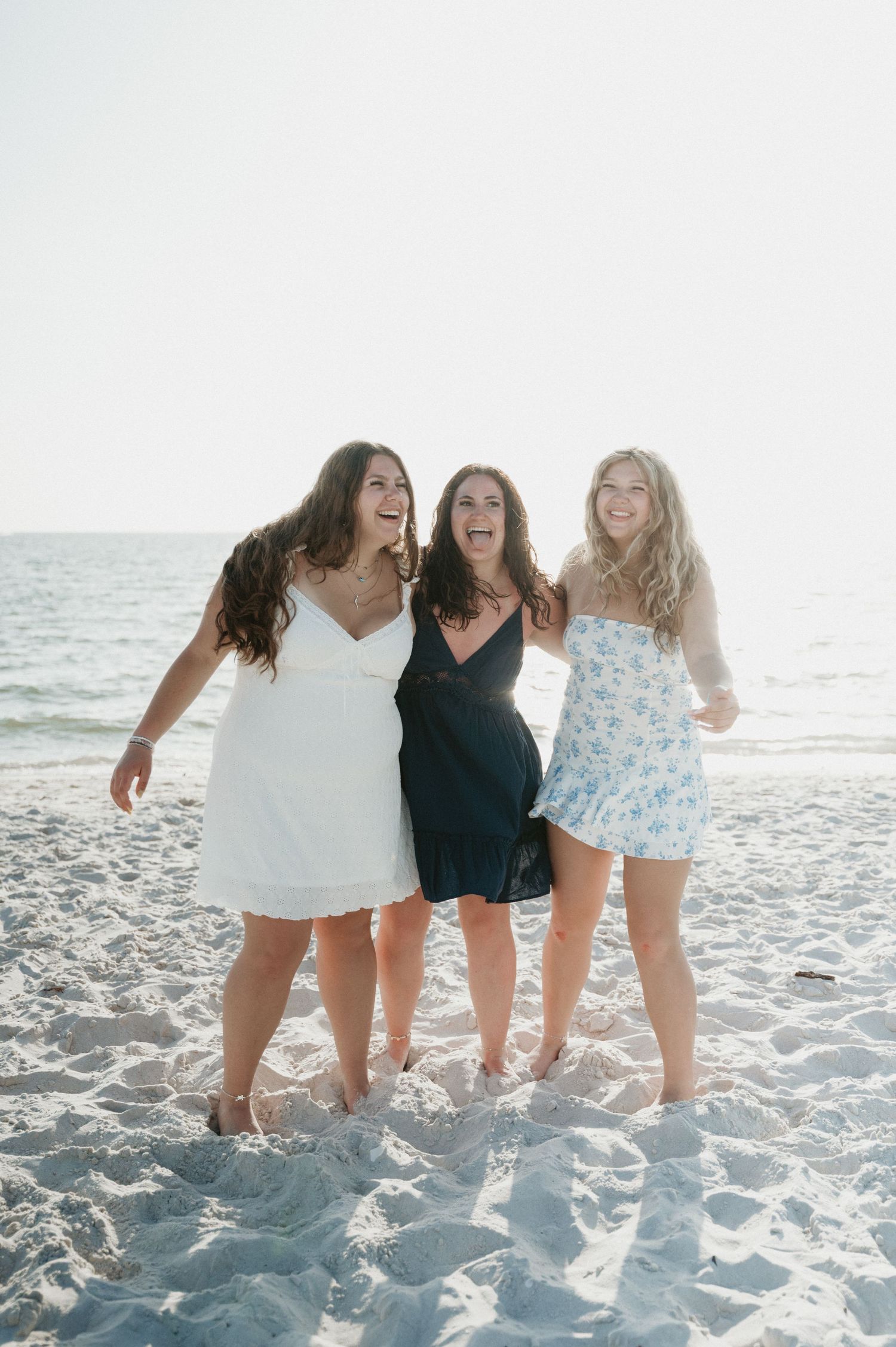 Friends laughing and having fun on a sunny beach.