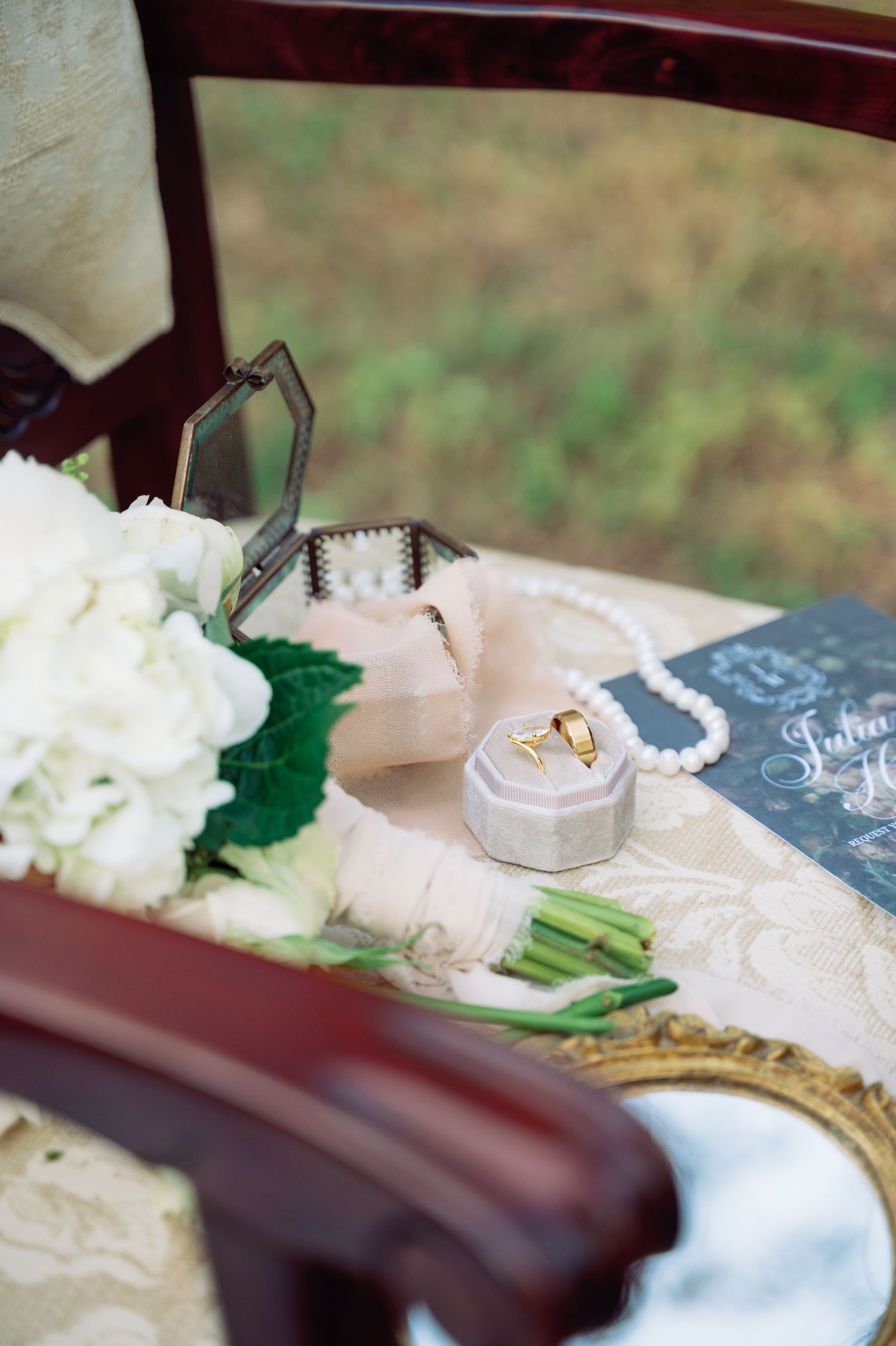 Wedding reception table detail with white flowers and chalkboard signs.