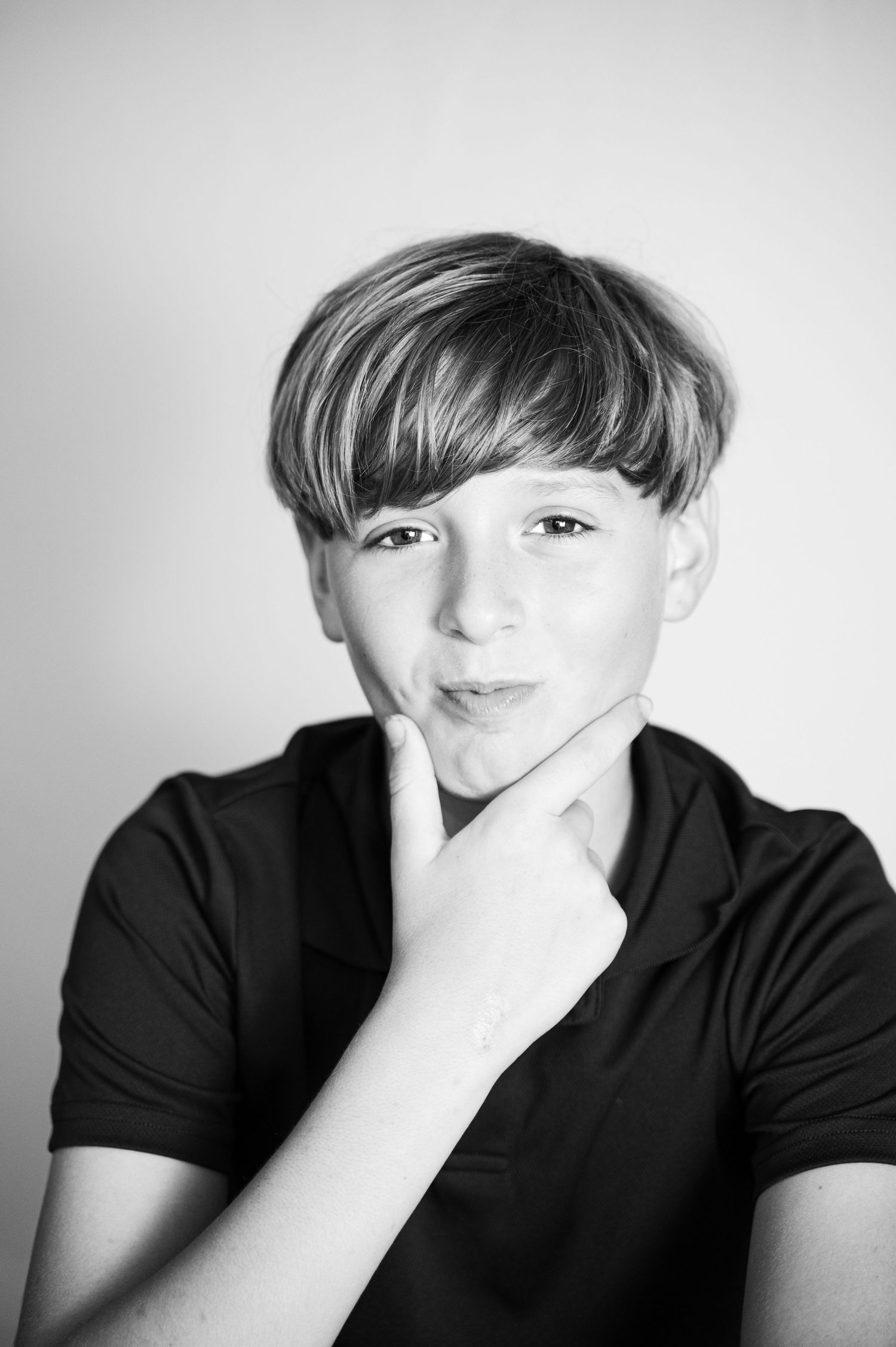 Black and white portrait sequence showing contemplative poses in dark clothing.