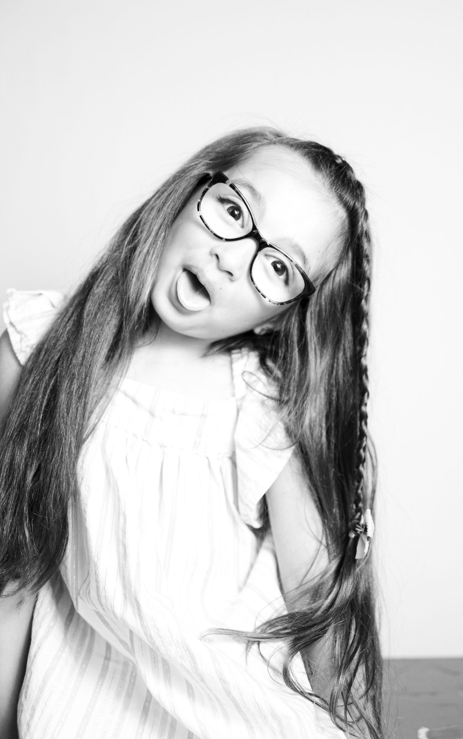 Black and white portrait series showing dramatic poses and expressions with glasses.