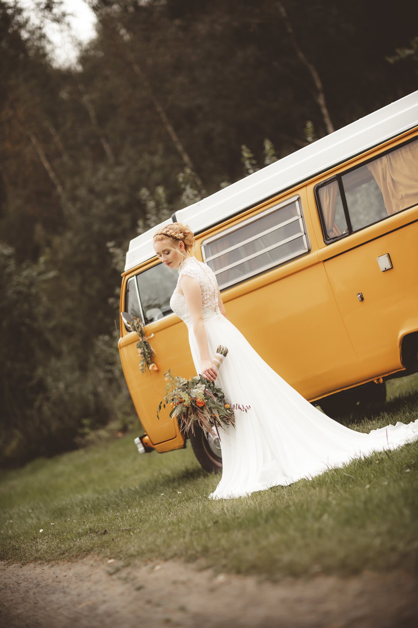Bridal portrait with vintage yellow van in rustic outdoor setting.