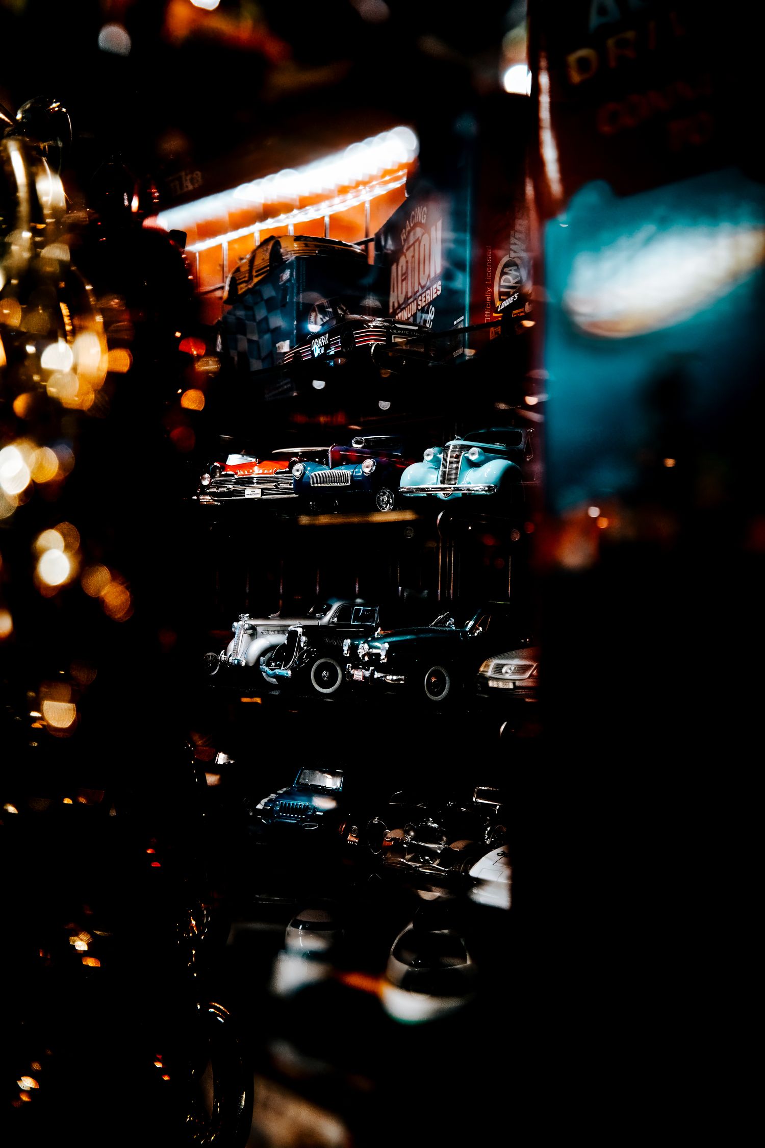 Blurred nighttime street scene with illuminated cars and neon lights creating a moody urban atmosphere.