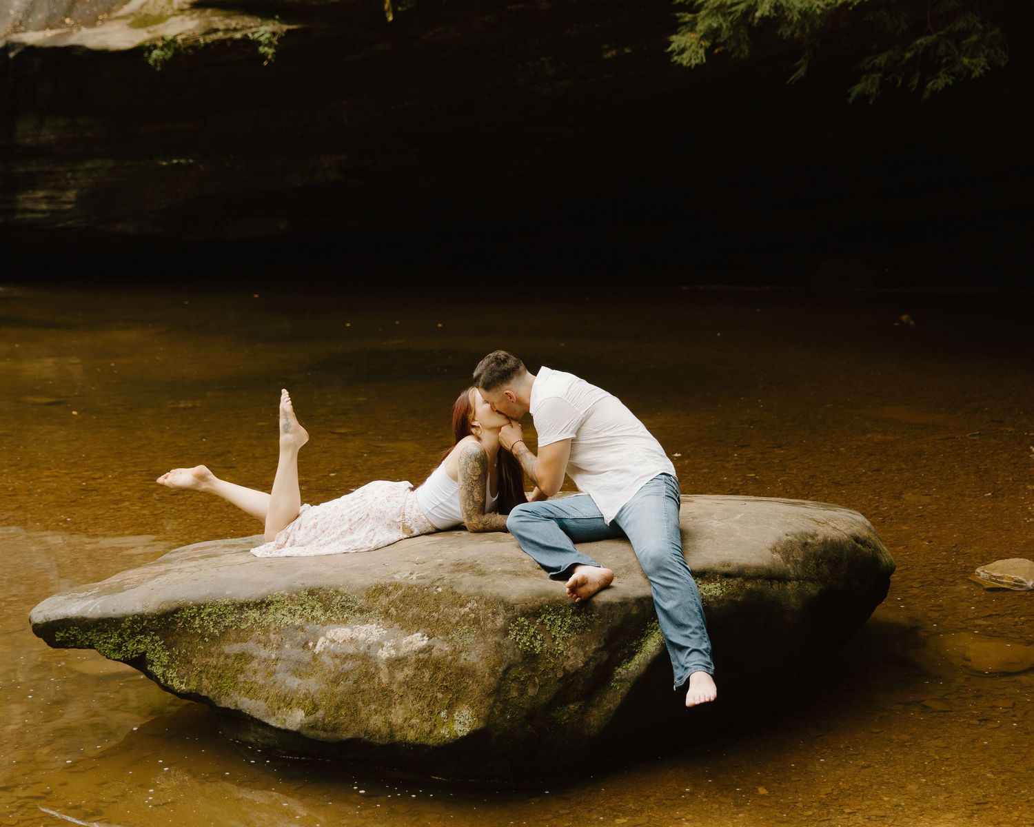 A person interacts with a giant manatee in shallow brown water over a sequence of multiple photos.