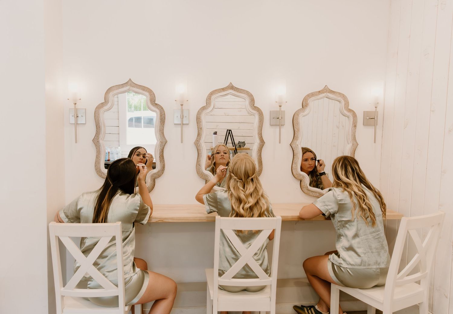 A series of photos showing a bride getting ready in an elegant white dress and veil.