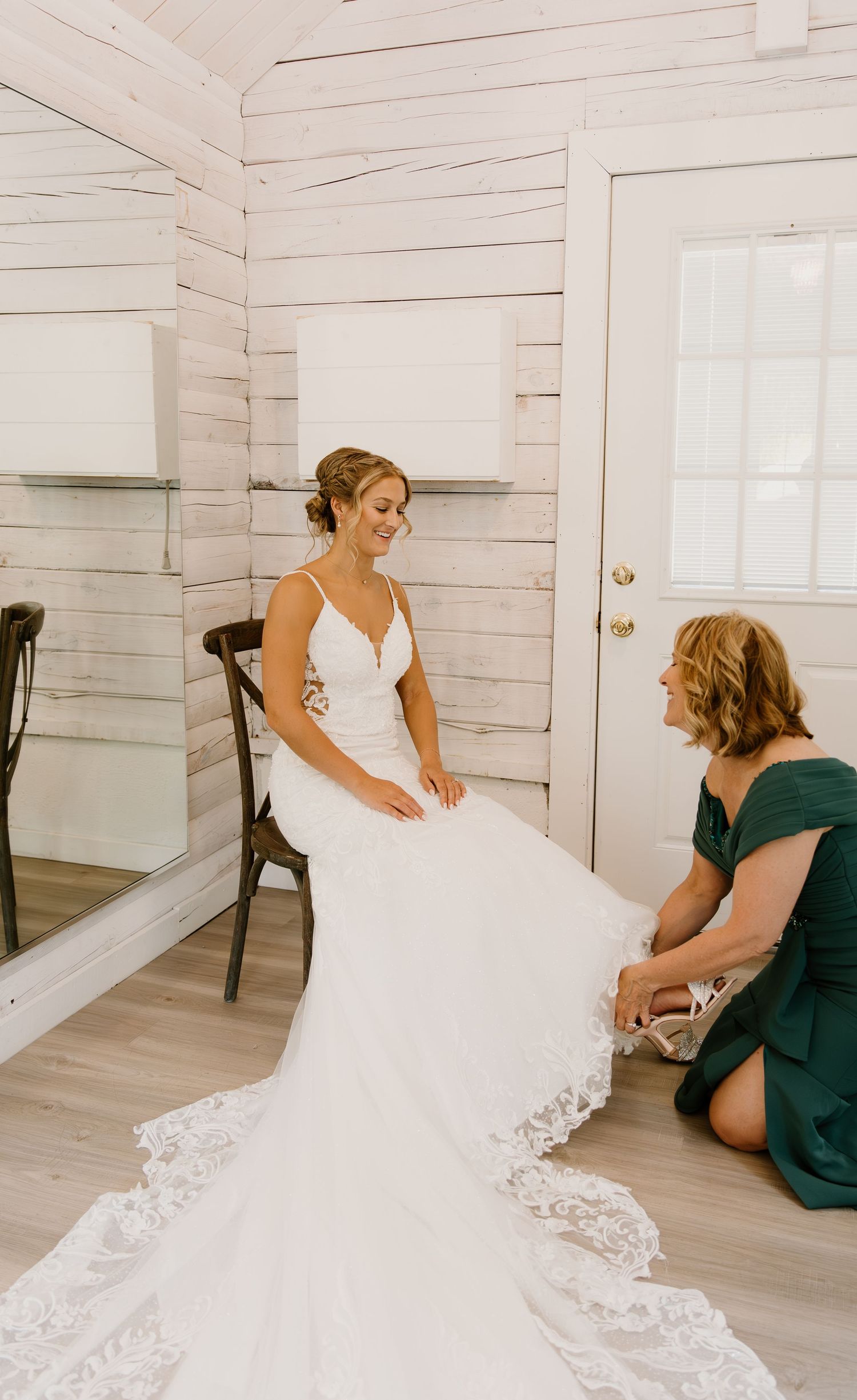Wedding dress preparation sequence showing intricate lace details and final adjustments in a white room.