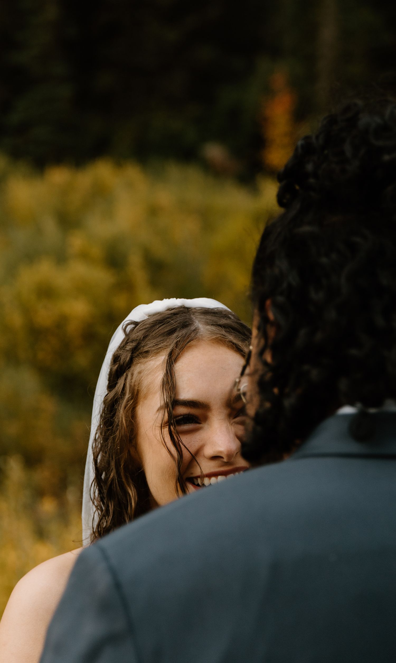 A couple shares an intimate moment during a golden hour outdoor photo session in nature.