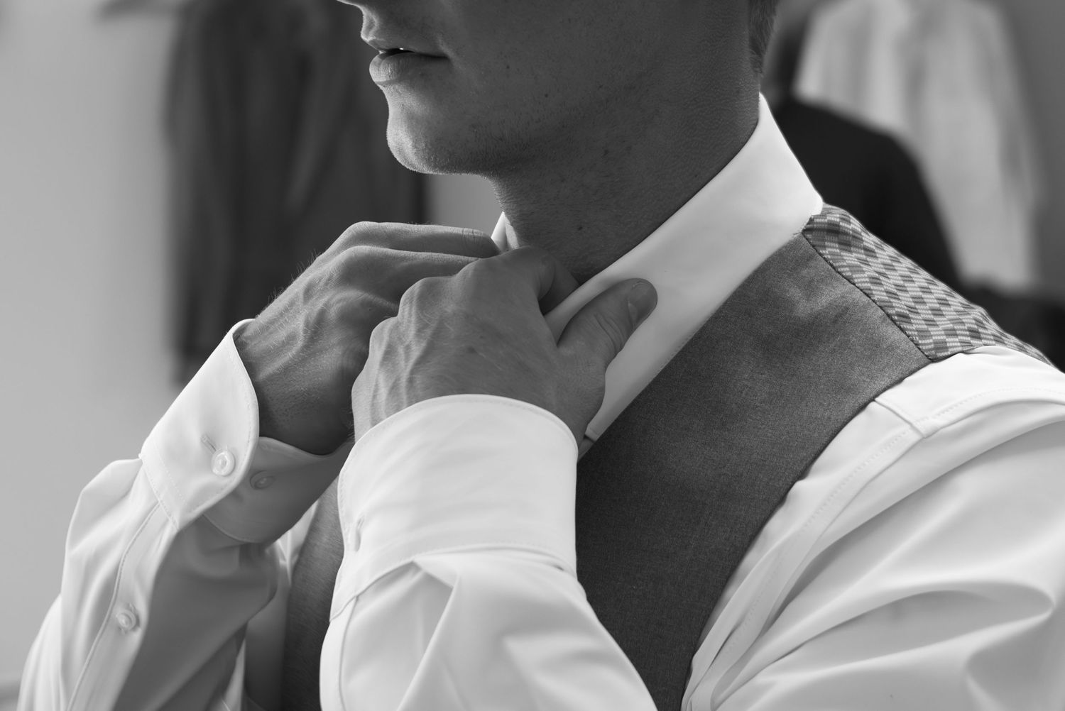 A black and white collage of people in white shirts sitting and looking in different directions.