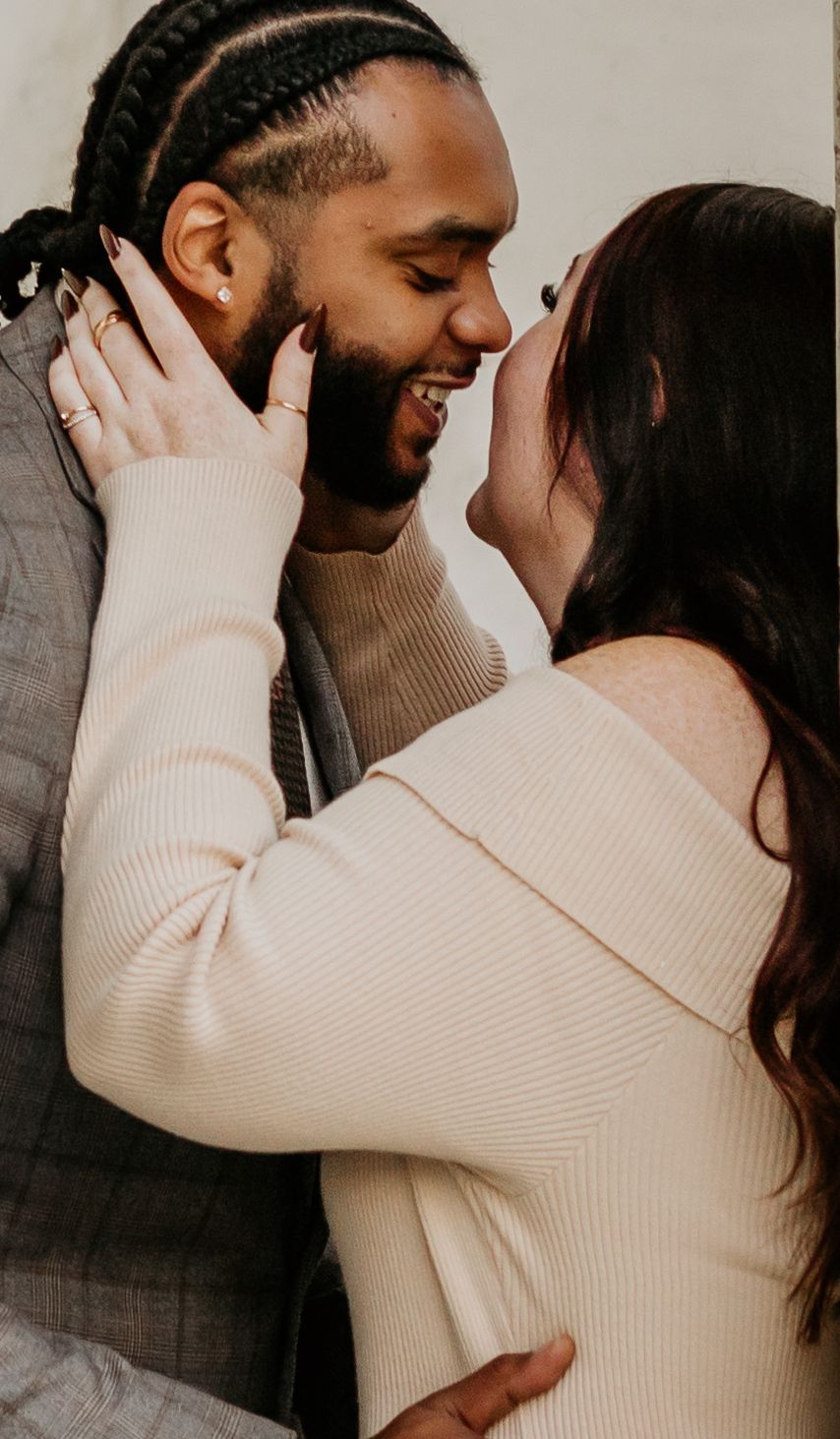 Intimate close-up portrait capturing a tender romantic moment in soft lighting.