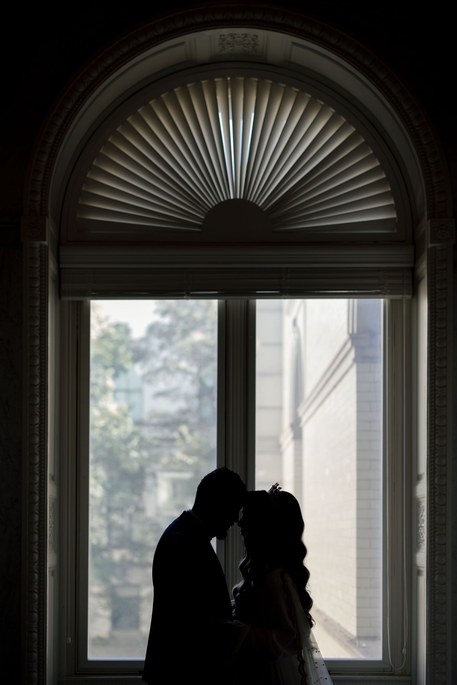 Architectural series showing arched windows with fan-shaped decorative elements creating dramatic silhouettes and shadows.