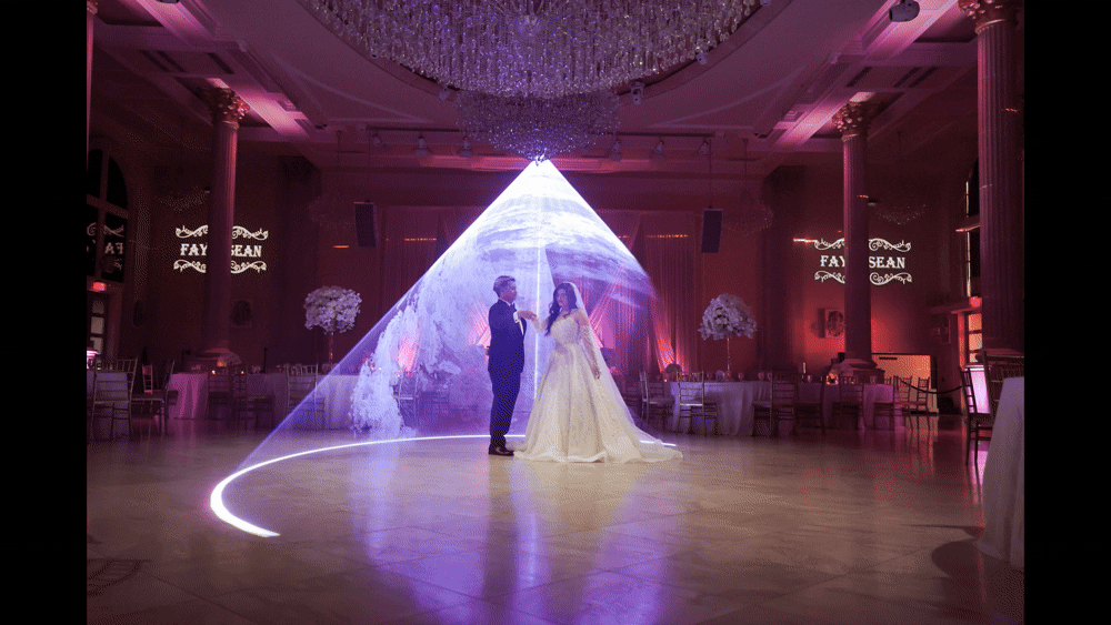 Bride and groom dancing under the lblue aser light at the Bellevue Chantilly venue in VA