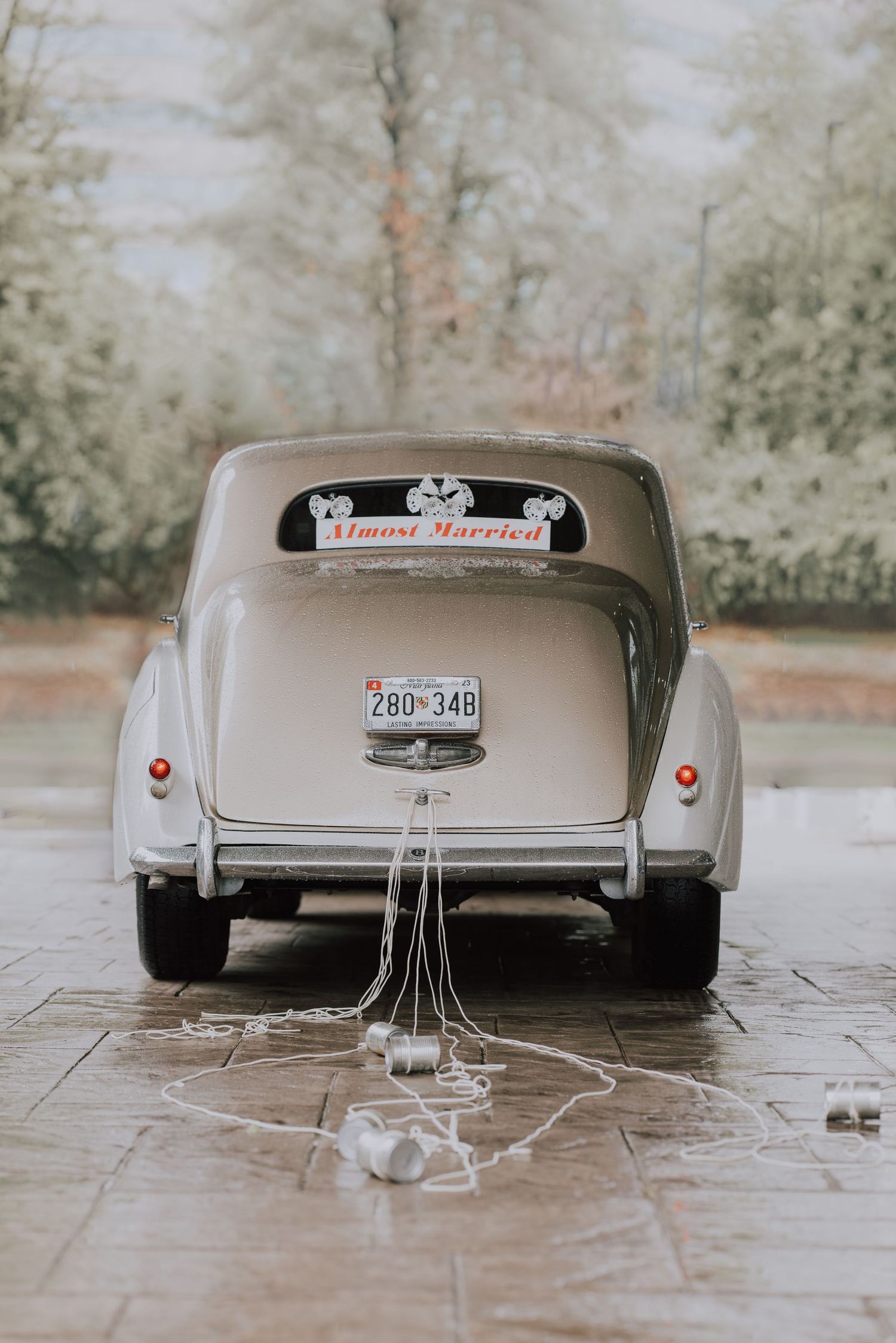 Four sequential photos show the back of a vintage silver car with 'Just Married' sign and tin cans tied to the bumper.