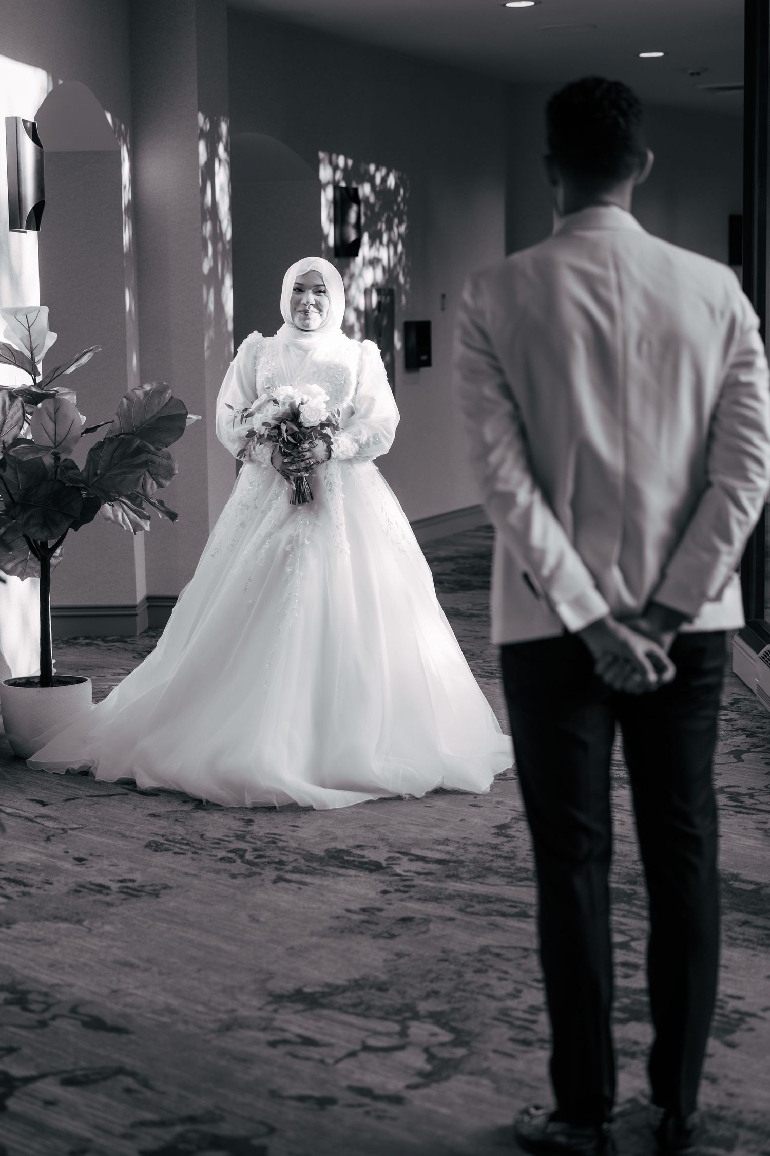 Black and white photo sequence showing a romantic first dance between newlyweds in an elegant ballroom setting.