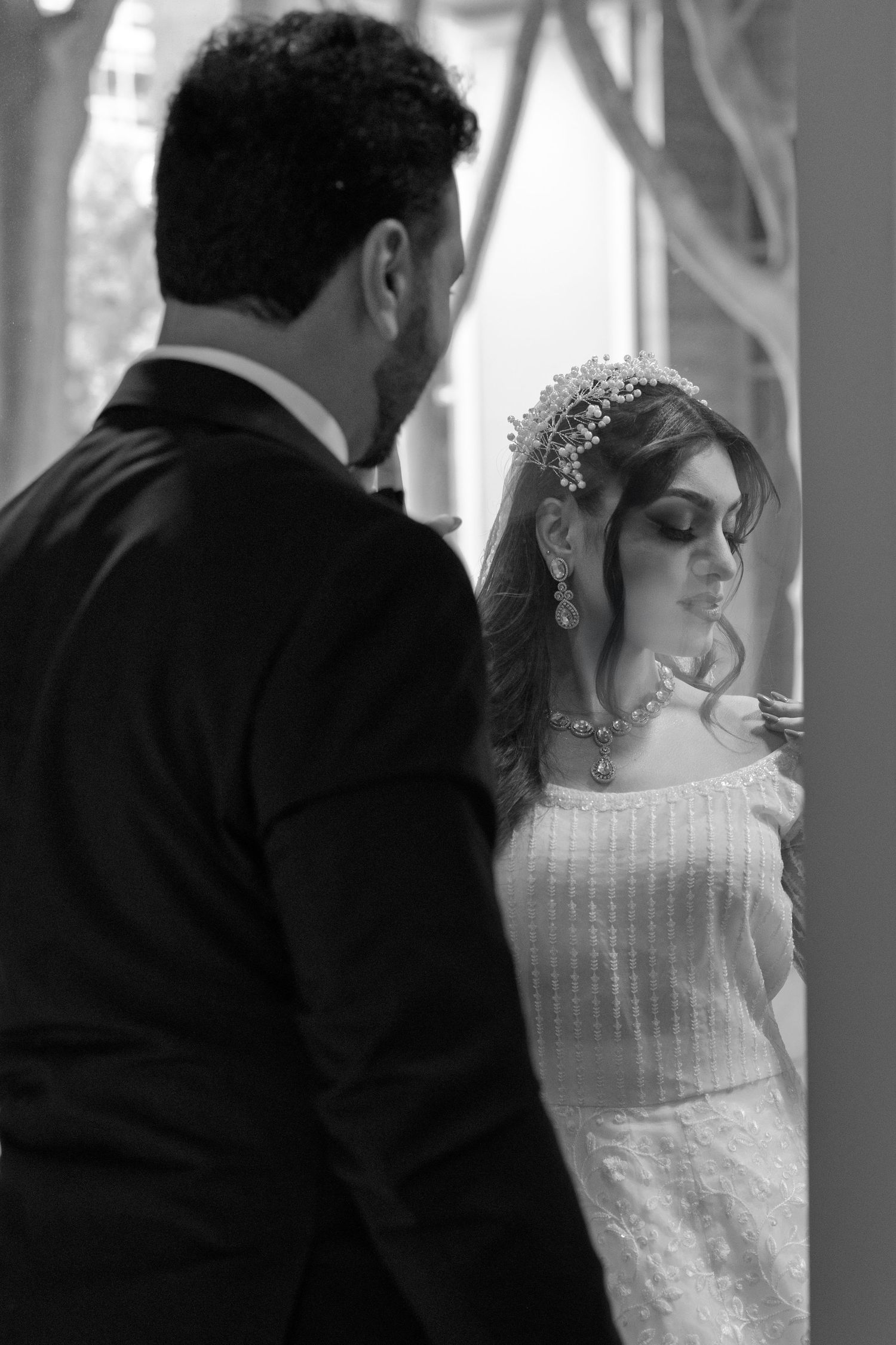 A black and white wedding photo sequence showing tender moments between bride and groom in profile view.