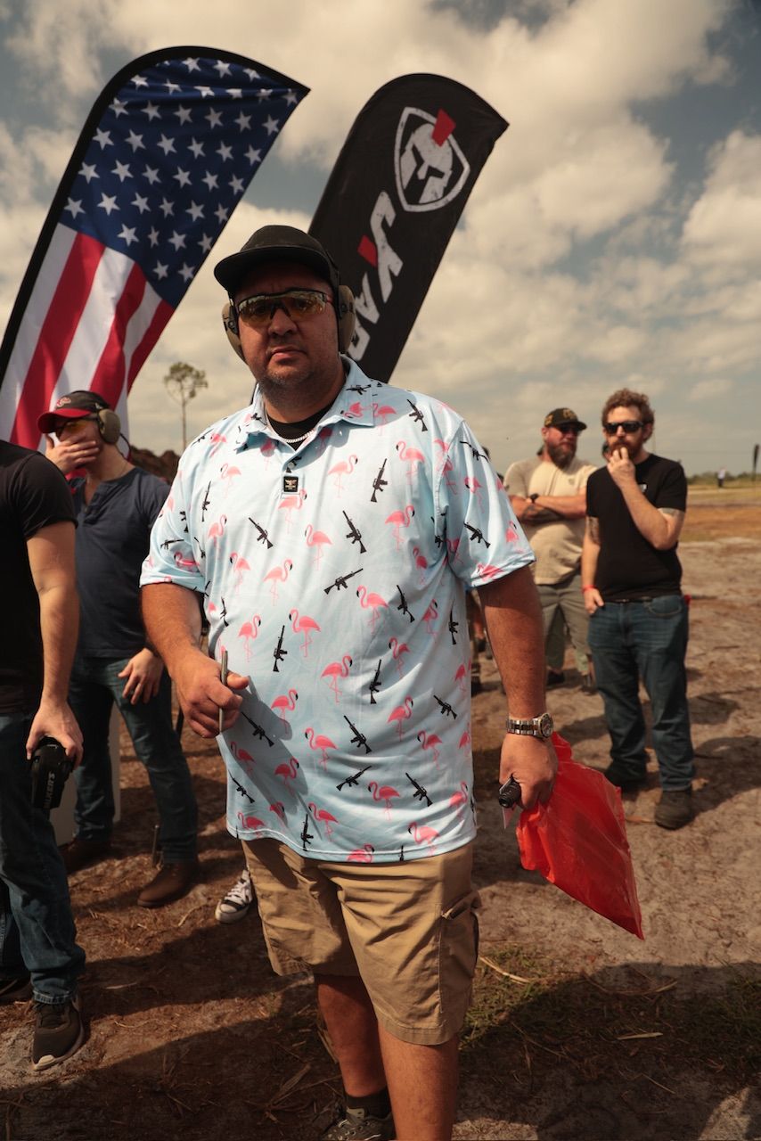Group gathered outdoors with American flags and patriotic attire at a daytime event.