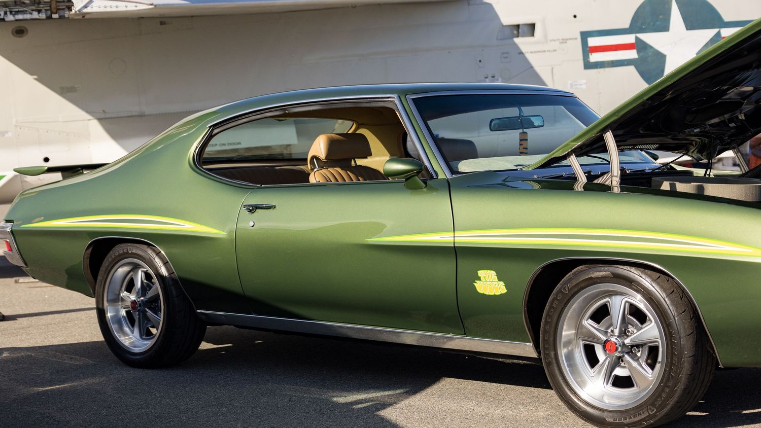 Classic green muscle car shown in a multi-panel collage with closeup details of its sleek exterior and custom wheels.