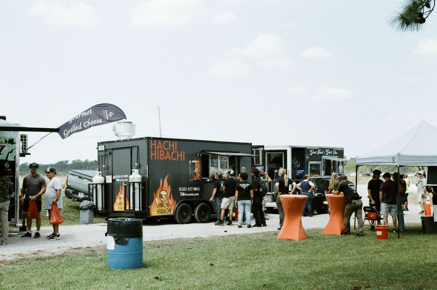 Hachi Hibachi food truck serving customers at an outdoor community event.