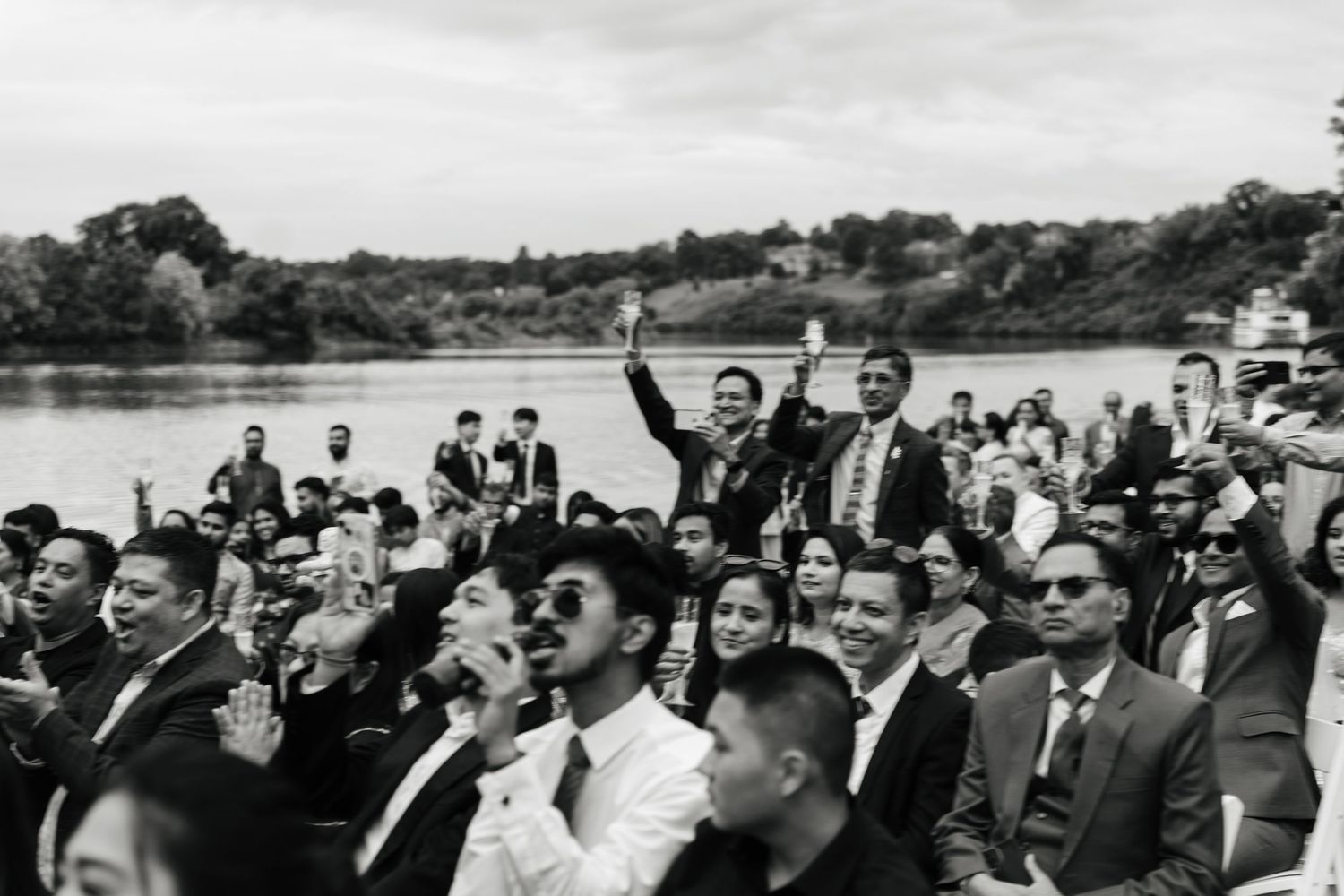 A large crowd of people in suits gathered outdoors during what appears to be an official government or business event.