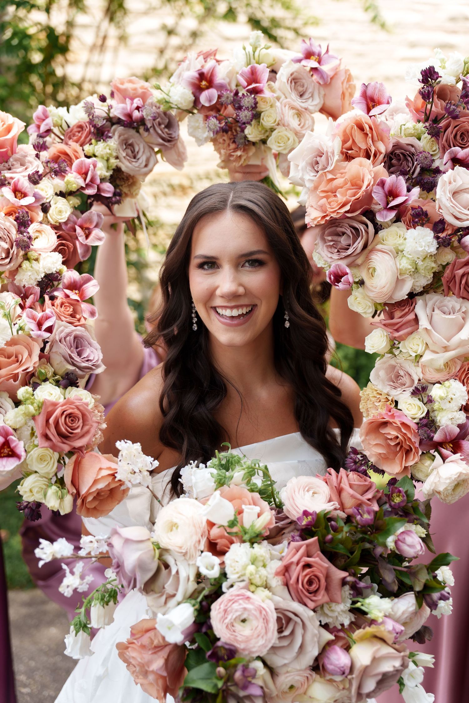 A romantic floral crown made of blush pink roses, white blooms and greenery for a wedding celebration.