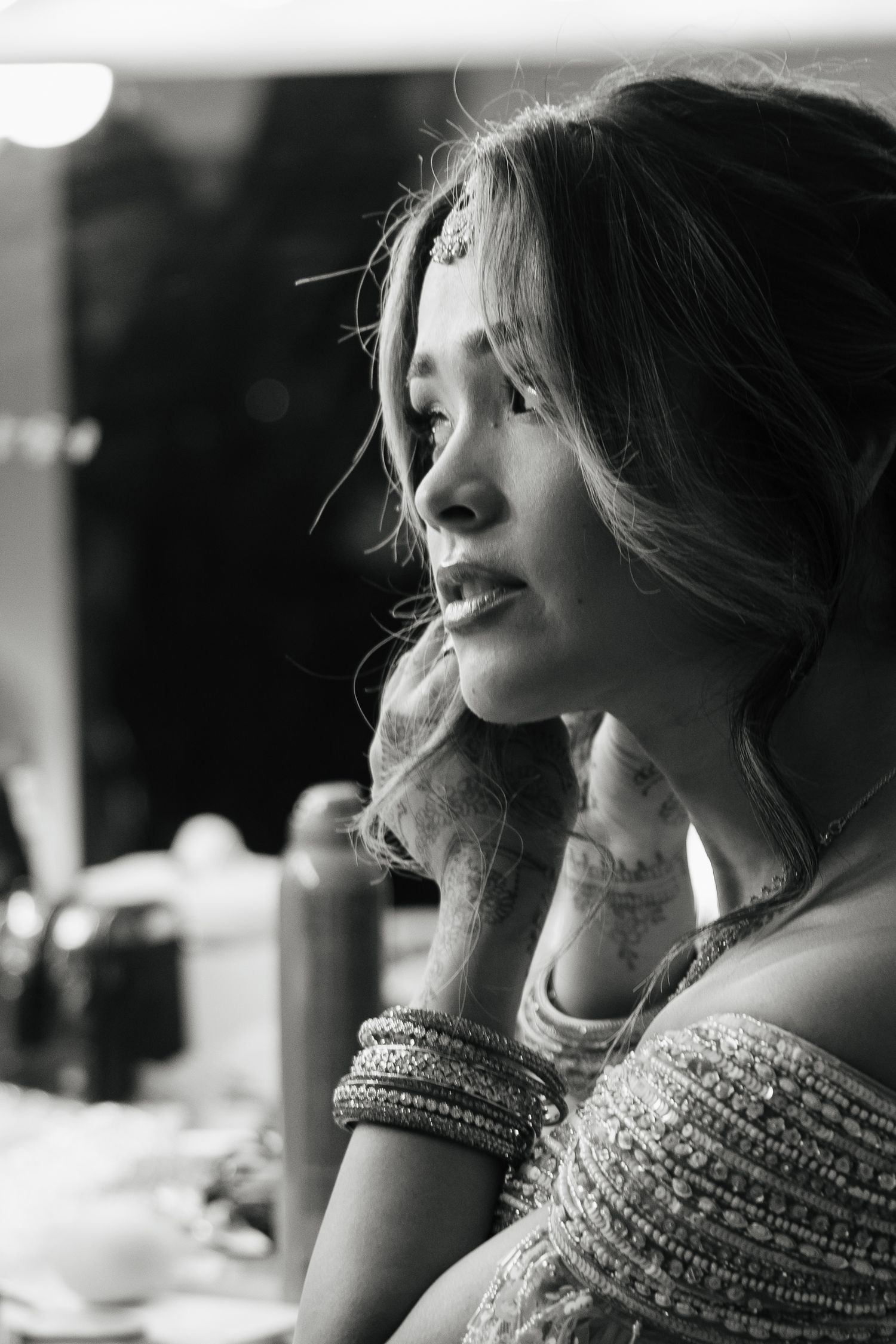 Black and white profile portraits showing elegant beaded neckline details.