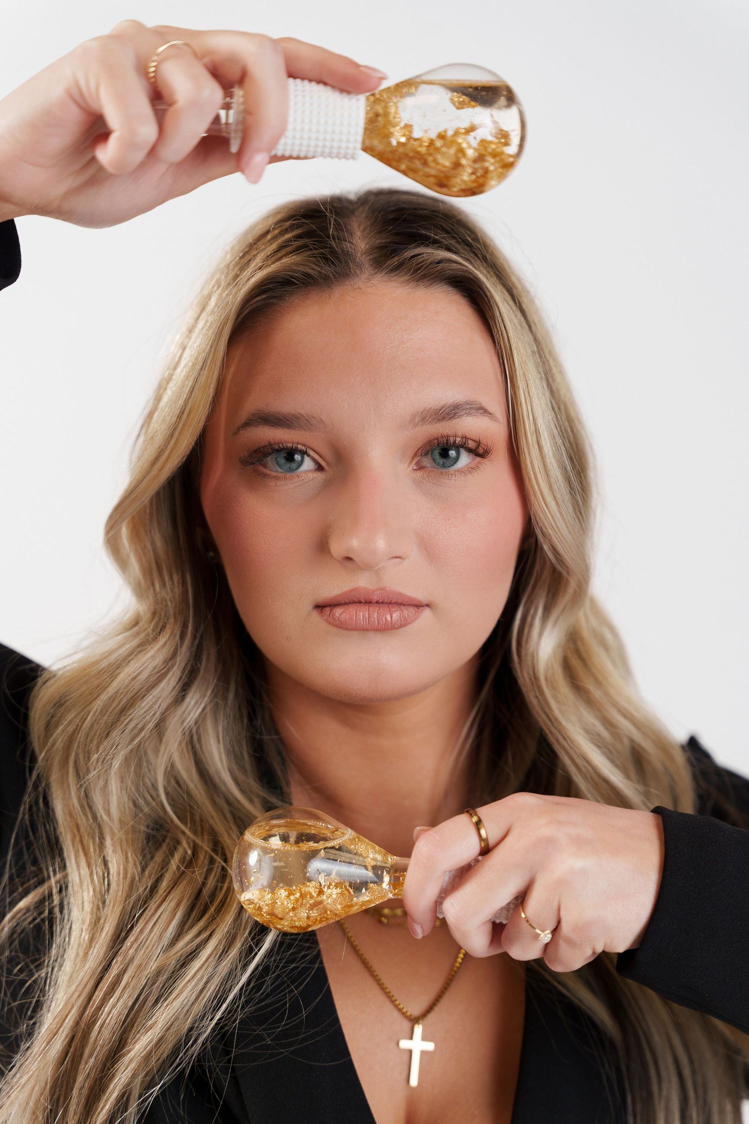 Four sequential shots show someone pouring gold glitter onto decorative jewelry against a white background.