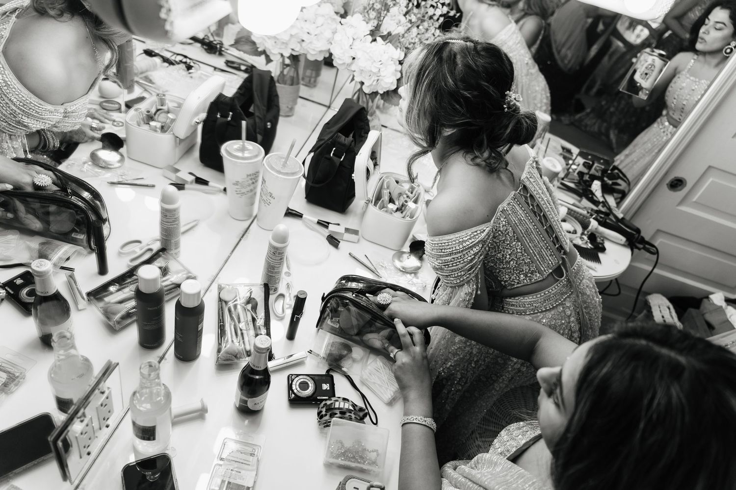 Behind the scenes black and white shots of wedding preparation moments.