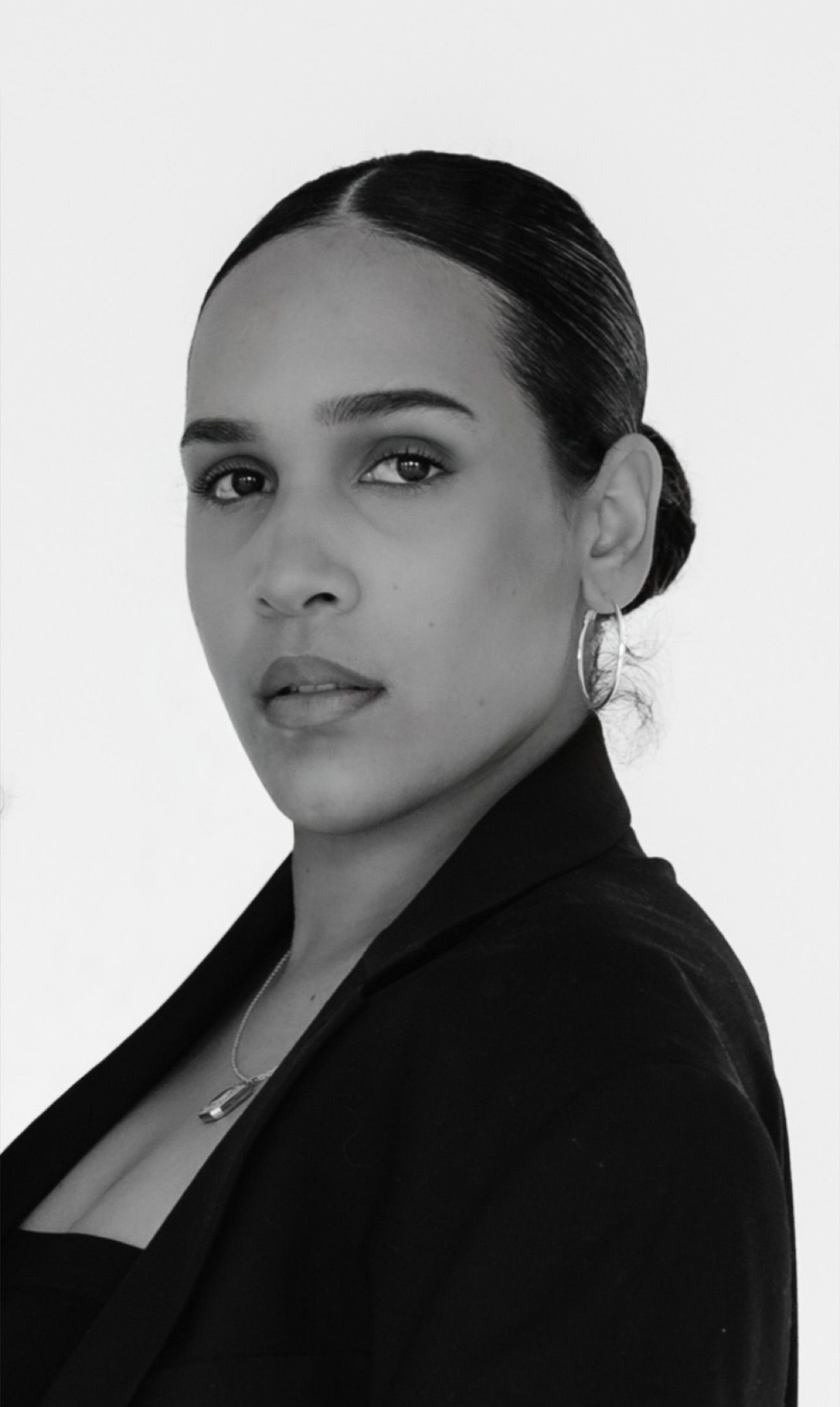Black and white portrait series showing a person in a dark blazer posing from different angles.