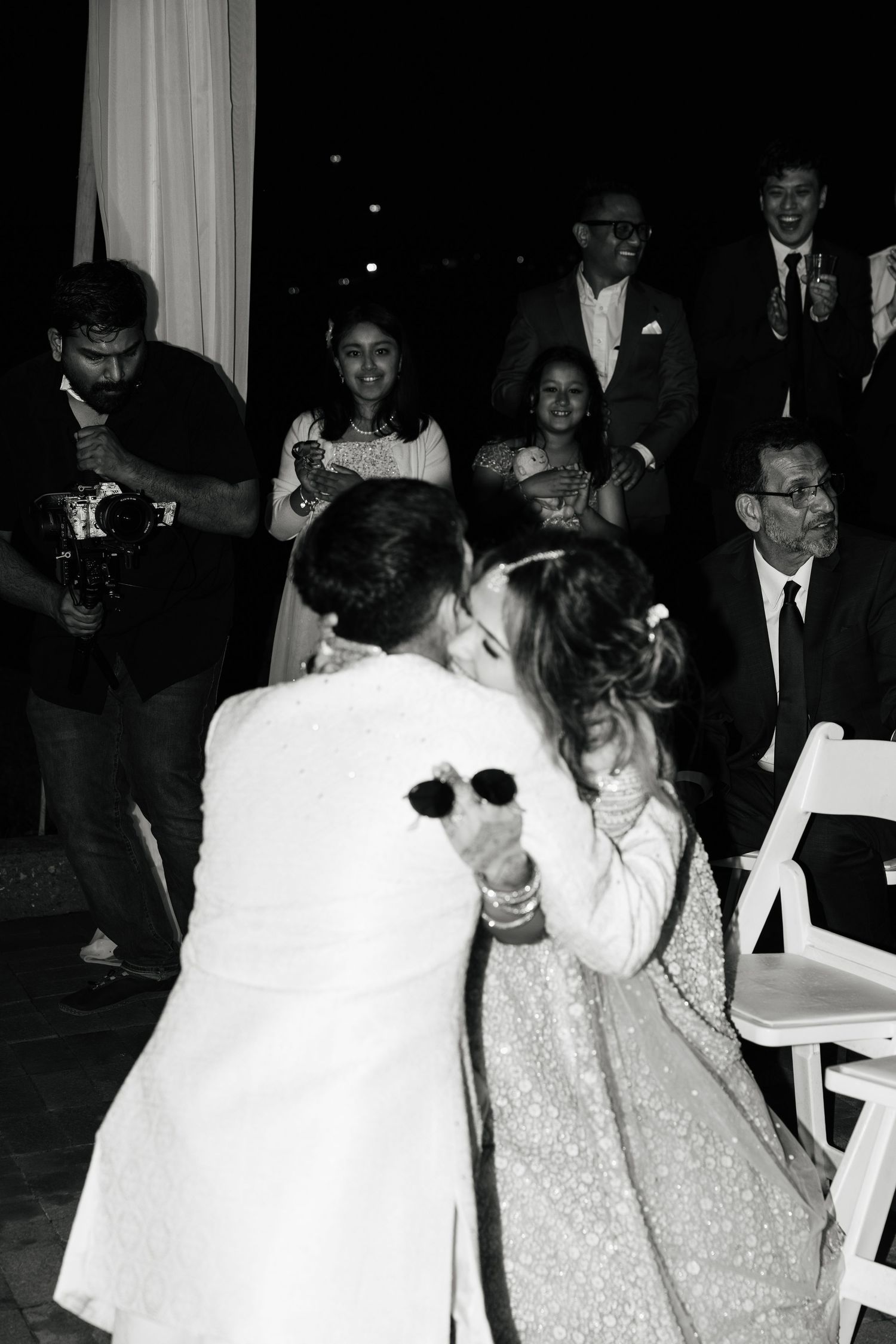 Black and white photos show people at a formal party celebrating and dancing together in festive attire.