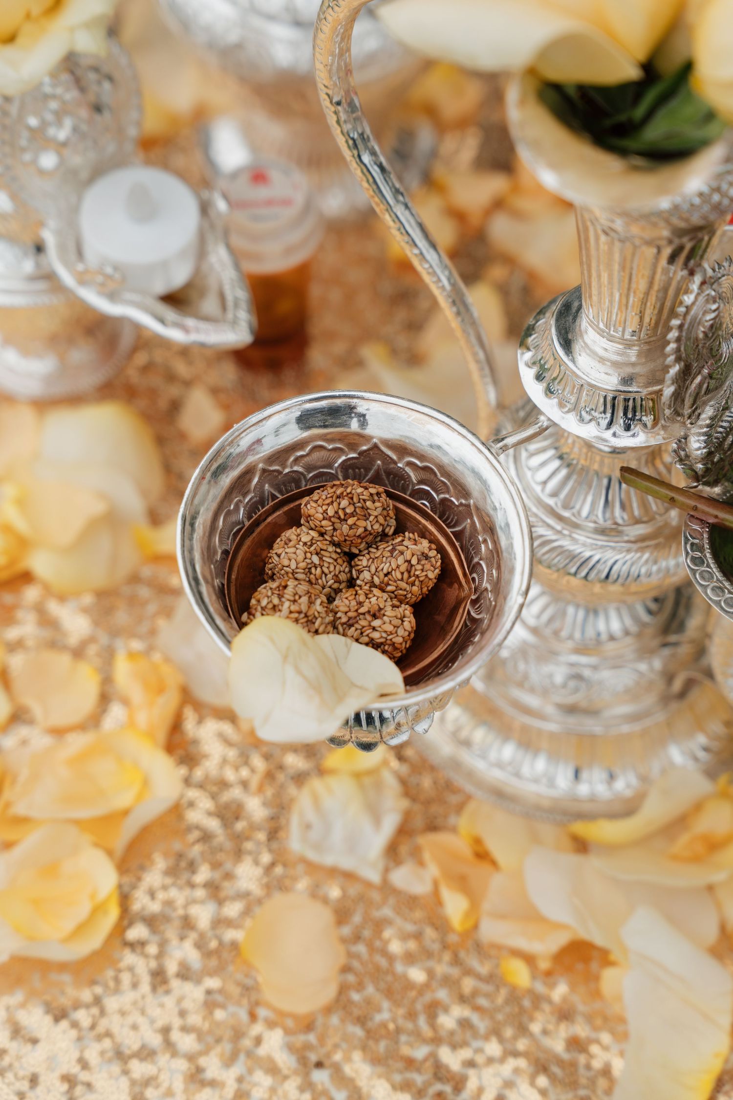 Elegant wedding dessert display with crystal stands and delicate truffles on a golden tablecloth.