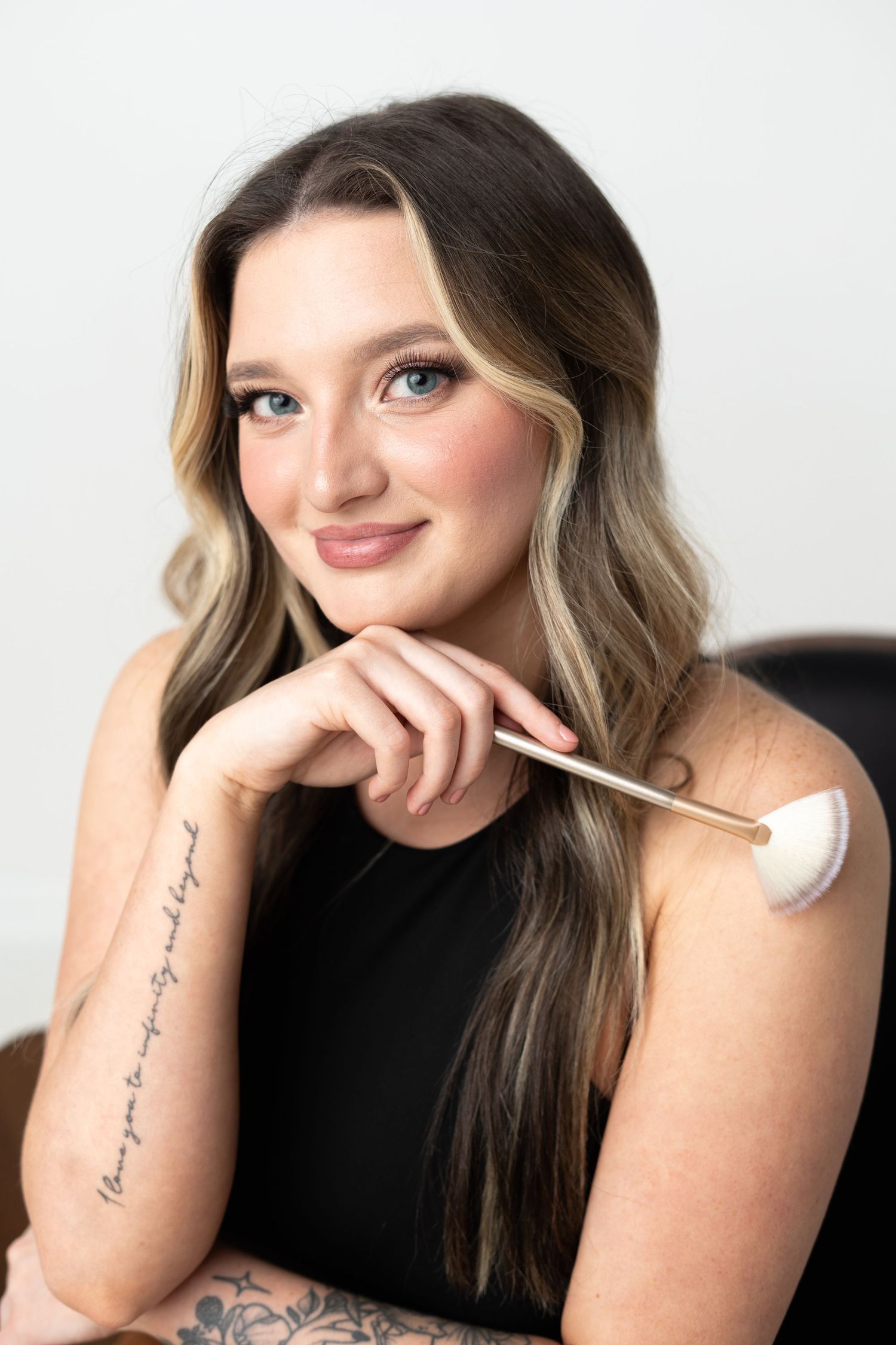 Casual portrait series shows subject wearing black against white background with arm tattoo visible.