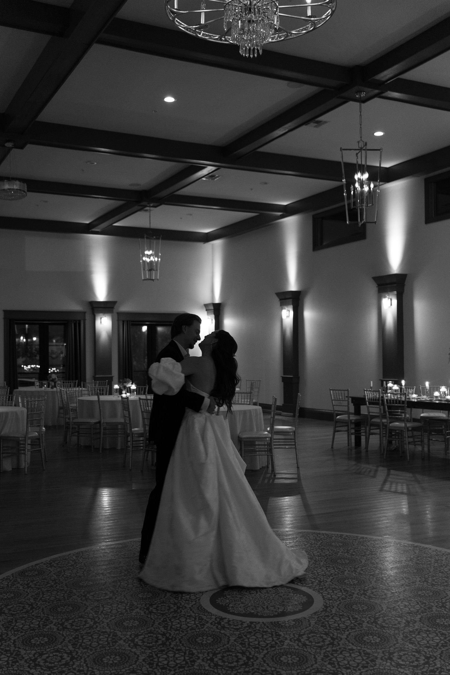Black and white photos of wedding reception dance floor moments under elegant chandeliers.