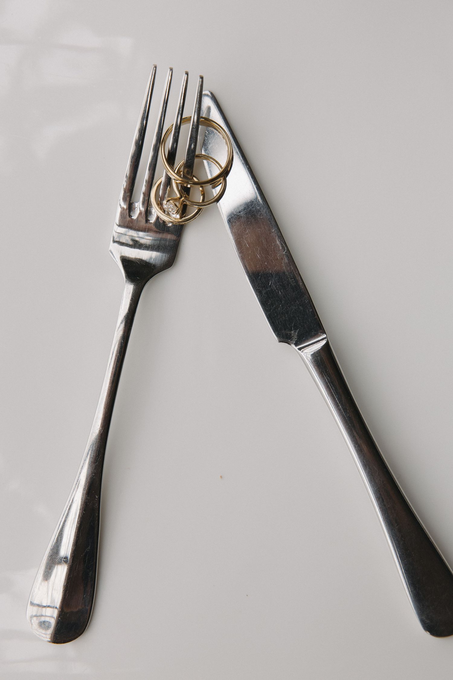 A fork and knife are placed on a white background.