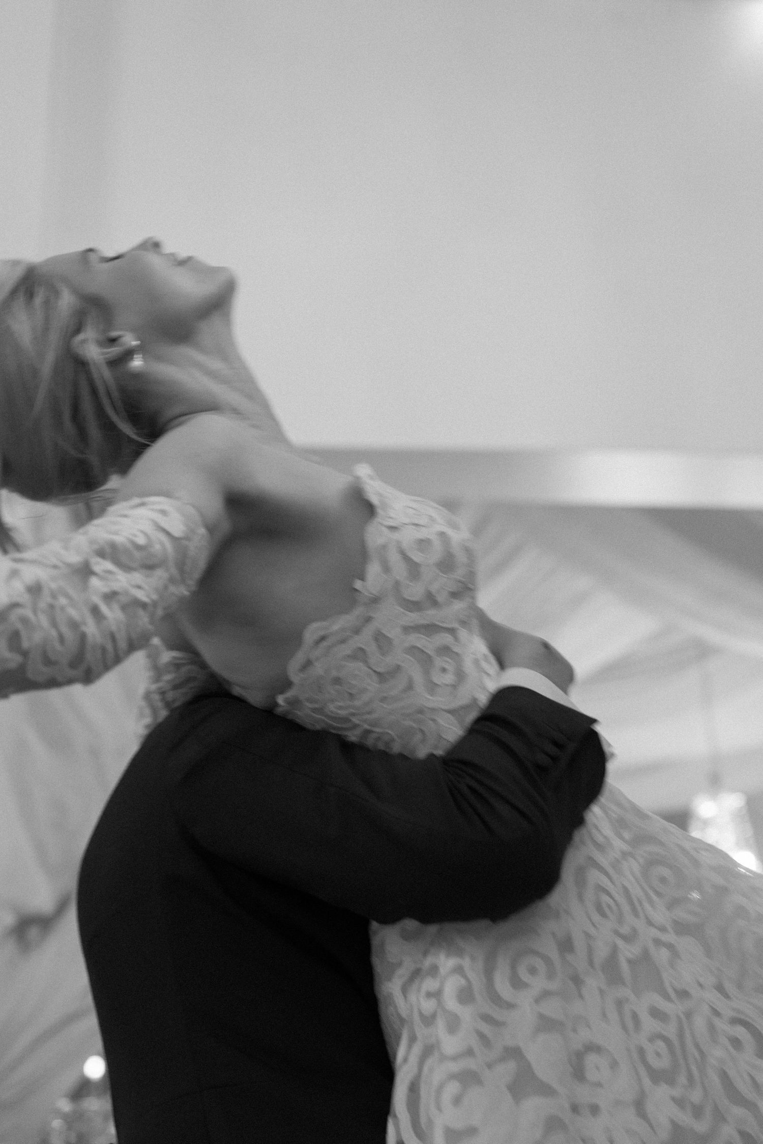 A series of black and white photos showing someone lying back in elegant lace clothing against a light background.