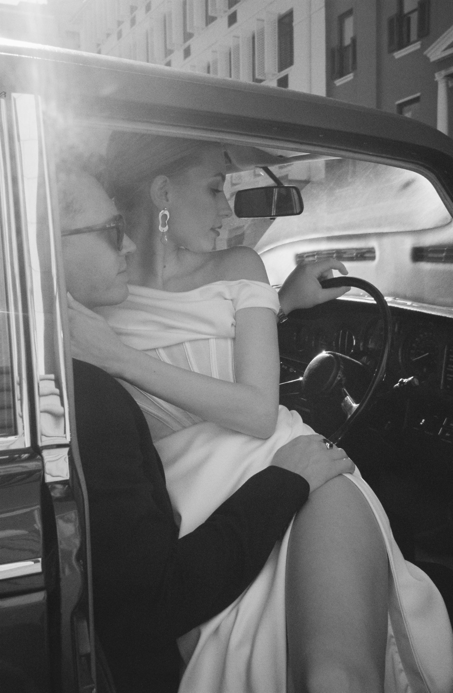 Series of black and white photos showing intimate moments in a car.