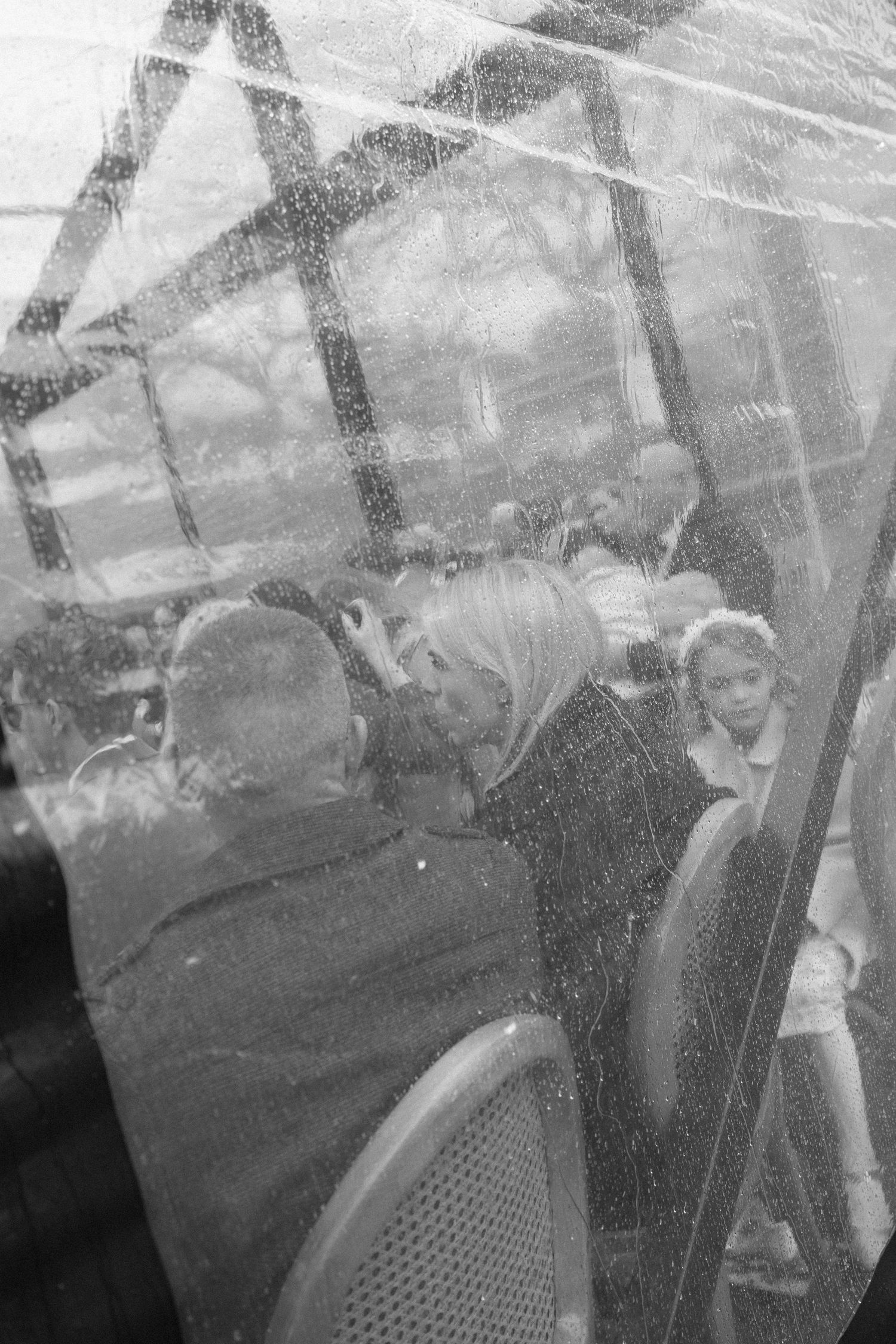 Vintage black and white photograph showing a group of people gathered outdoors in what appears to be a social setting.