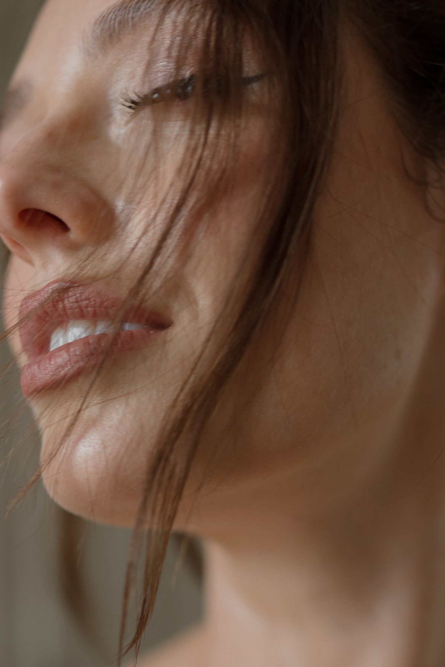 Close-up photo showing lips and partial profile view against a soft blurred background.