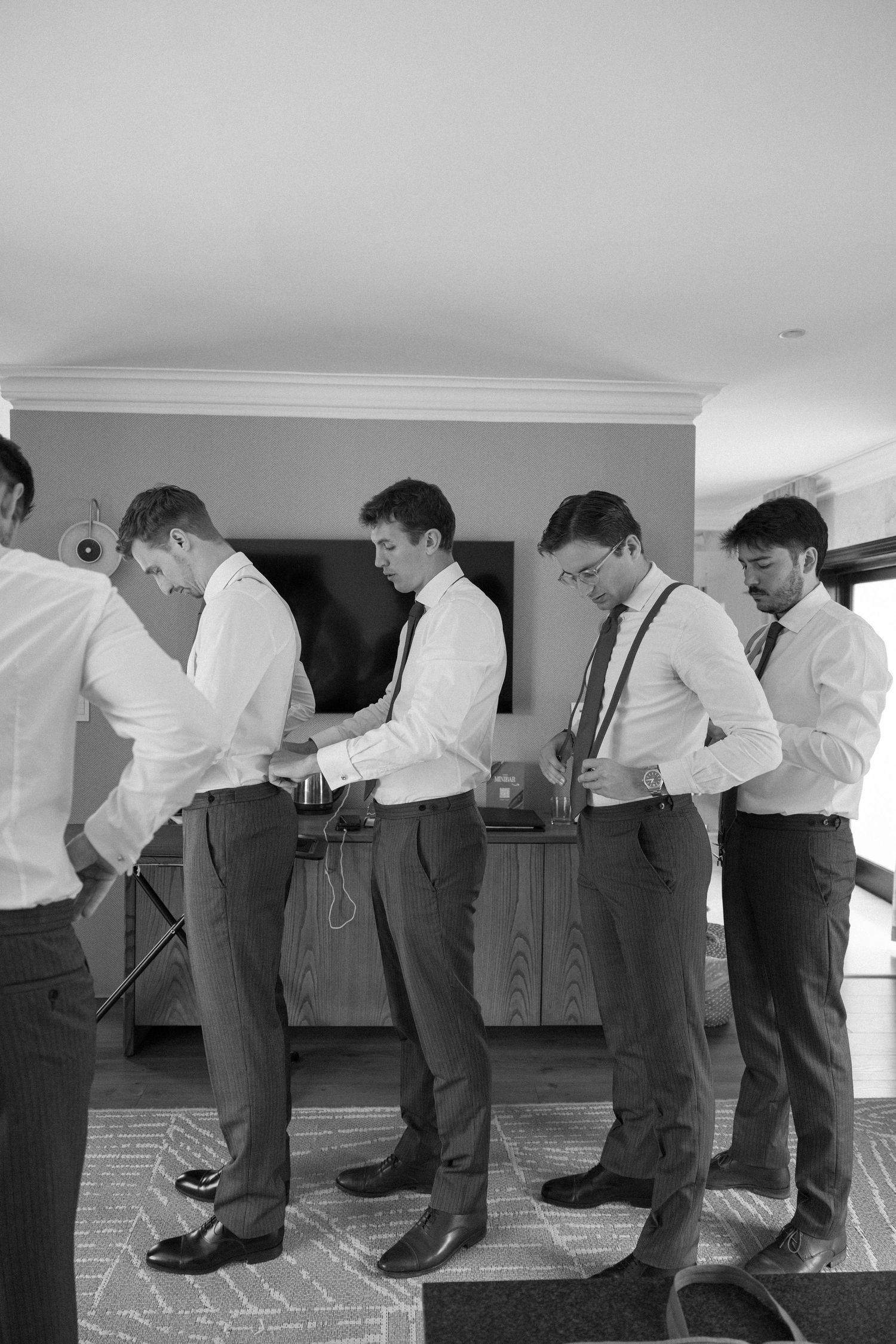 Black and white photo sequence showing groomsmen in matching attire bowing in synchronized formation.