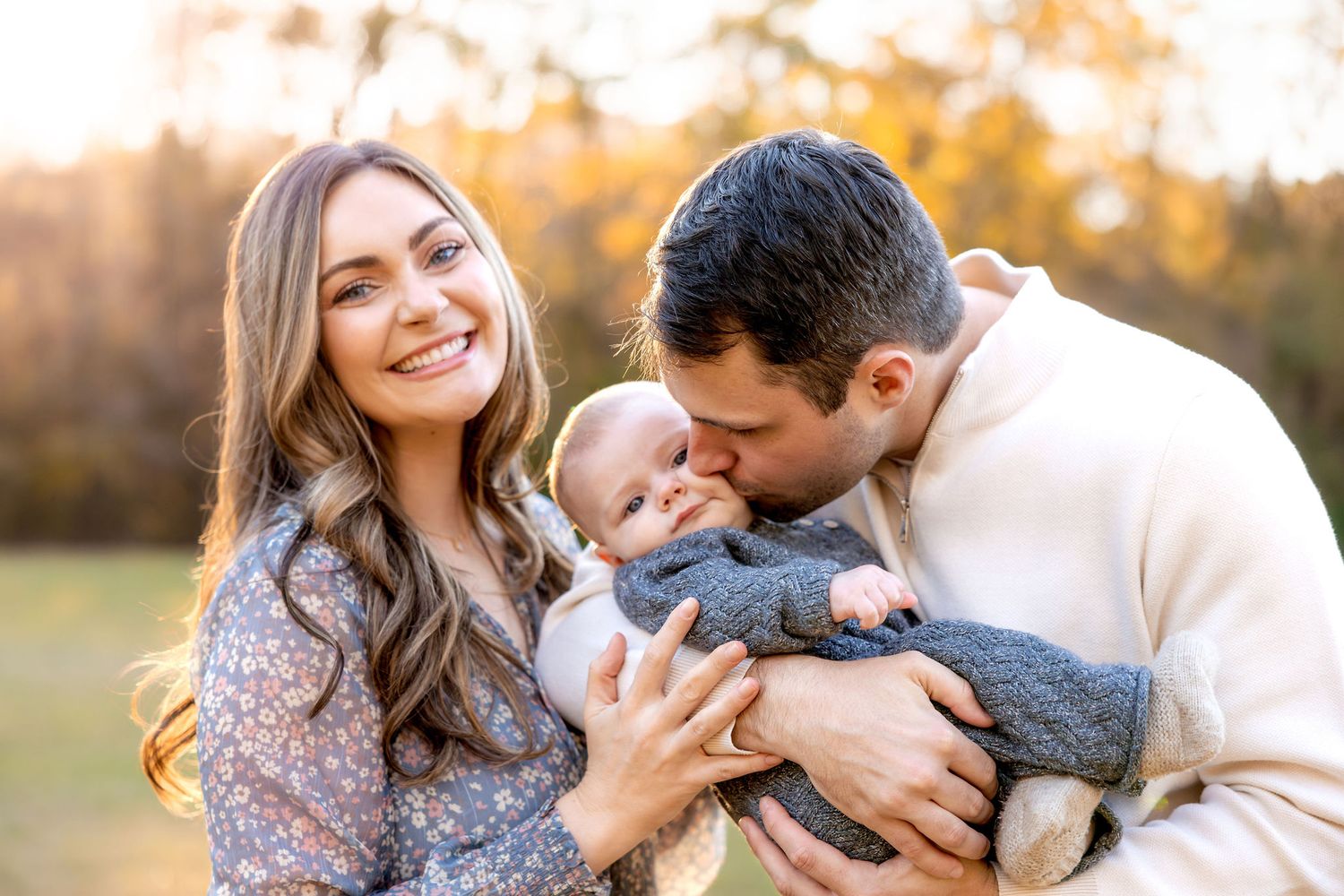 Family photo session capturing tender moments during golden hour outdoors.