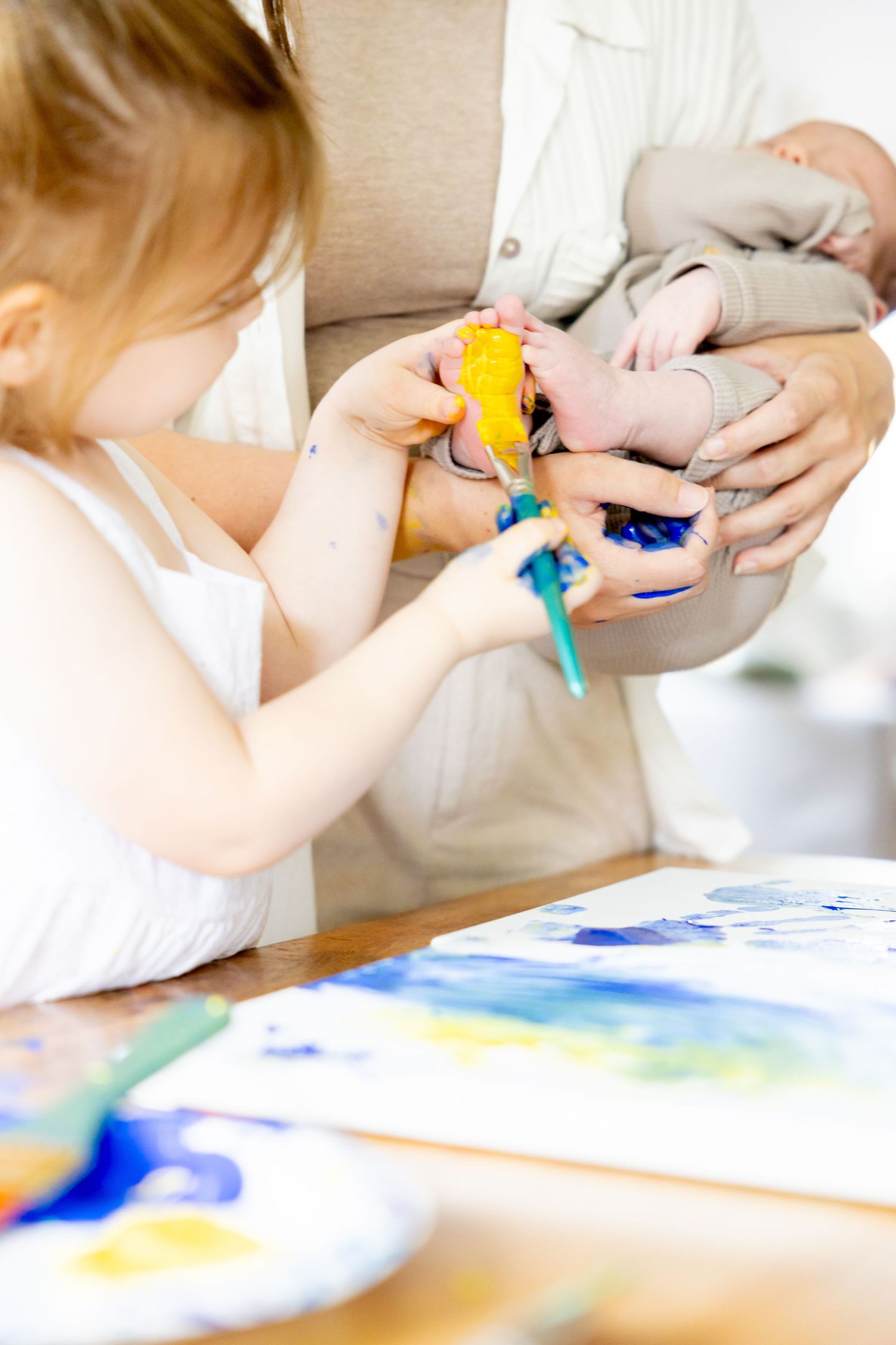 Child painting with bright colors while participating in an art activity.