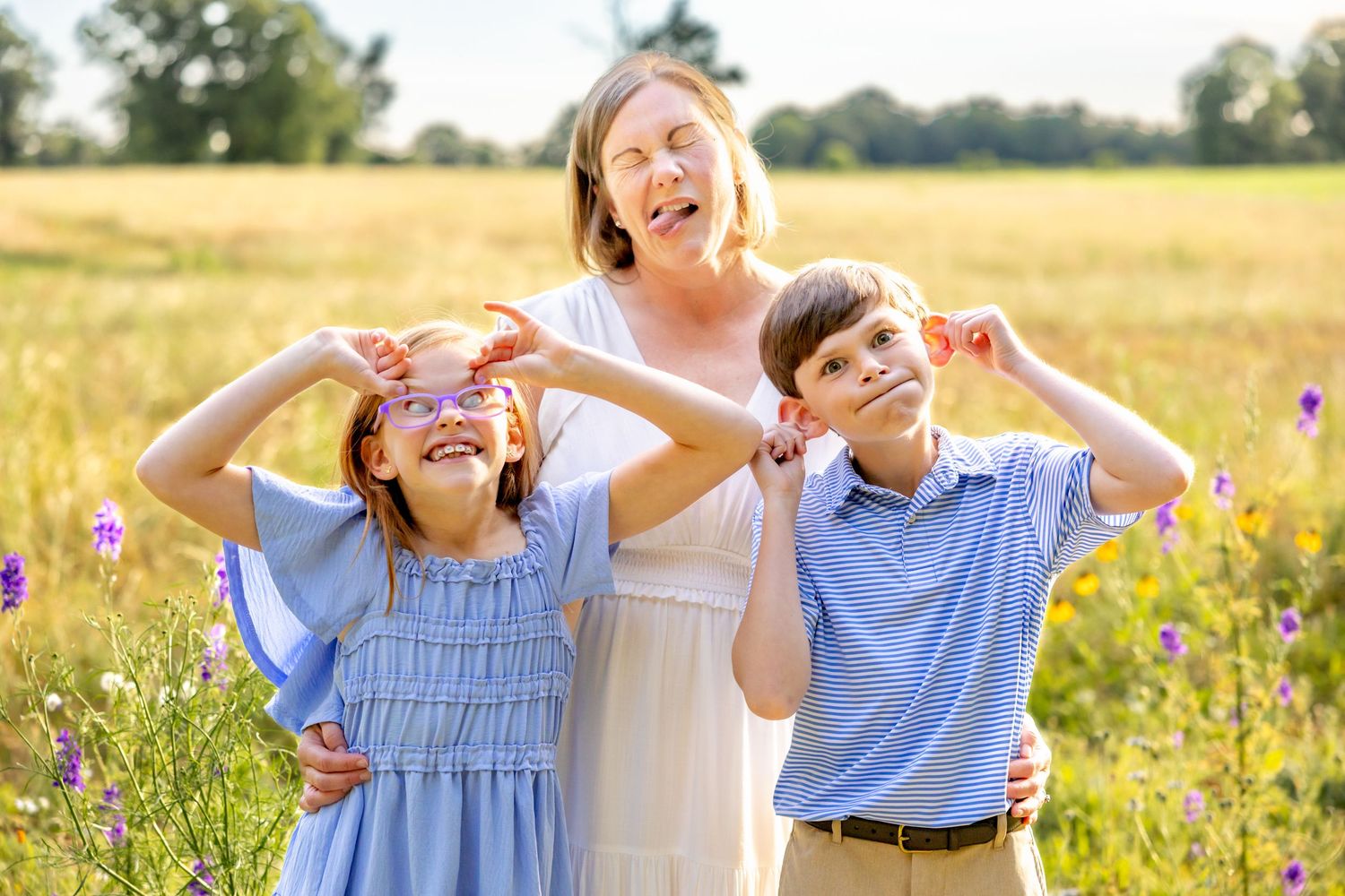 Joyful outdoor portrait session in a summer field with blooming wildflowers at Blue Hill Garden in Monroe, NC.