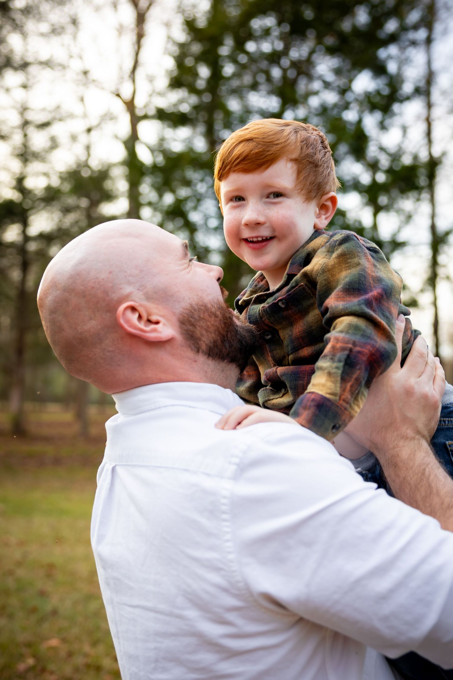 Joyful moment between parent and child outdoors in autumn setting.