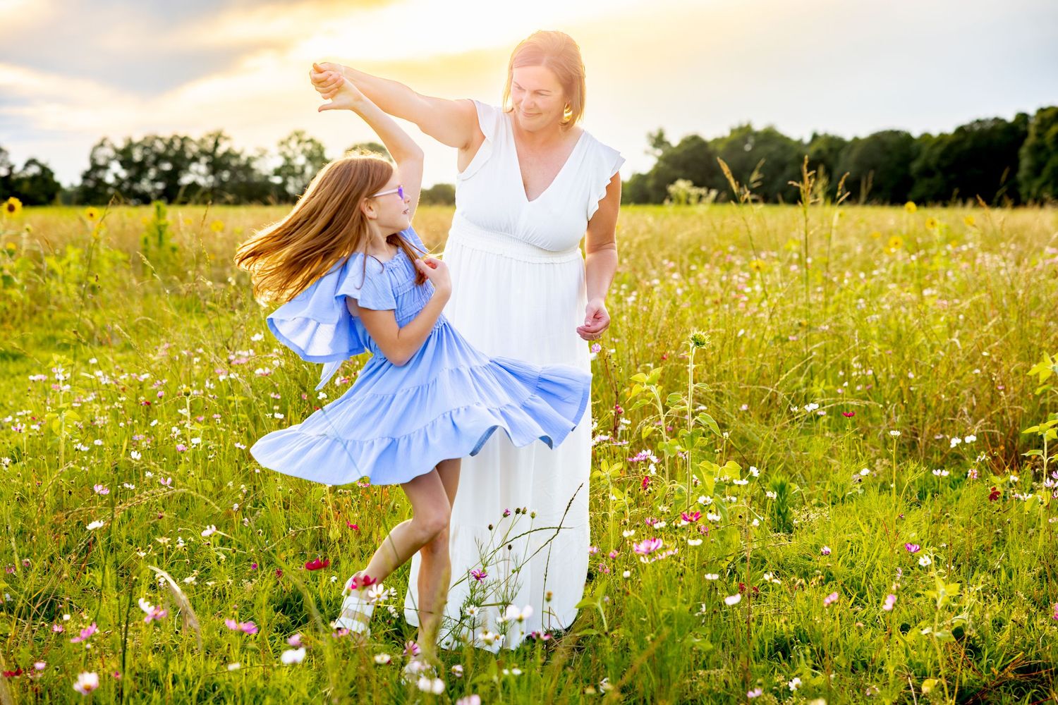 Joyful dancing and twirling in a sun-drenched wildflower field at sunset at Blue Hill Garden in Monroe, NC.