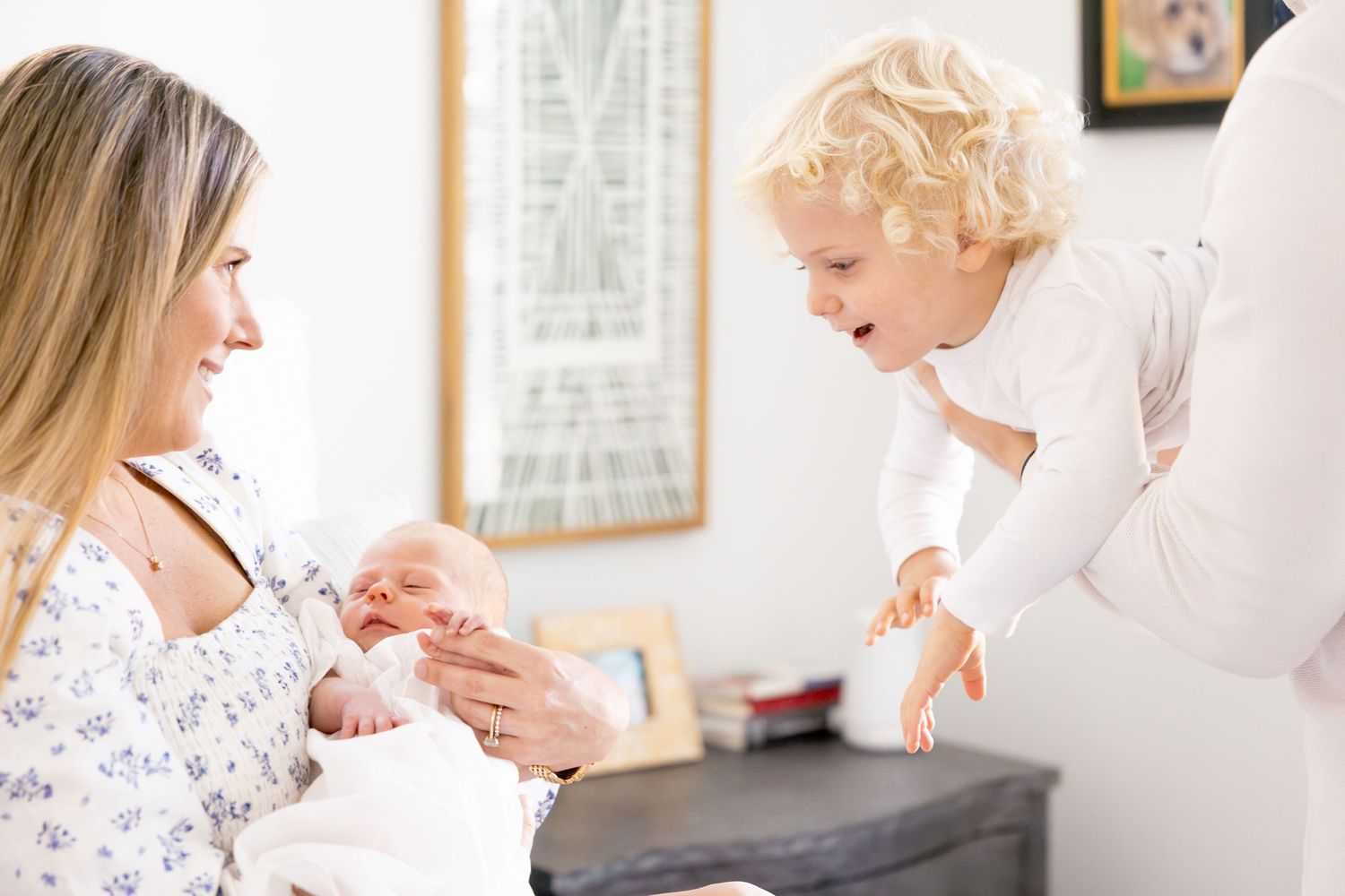 Family sharing tender moment together in living room setting.