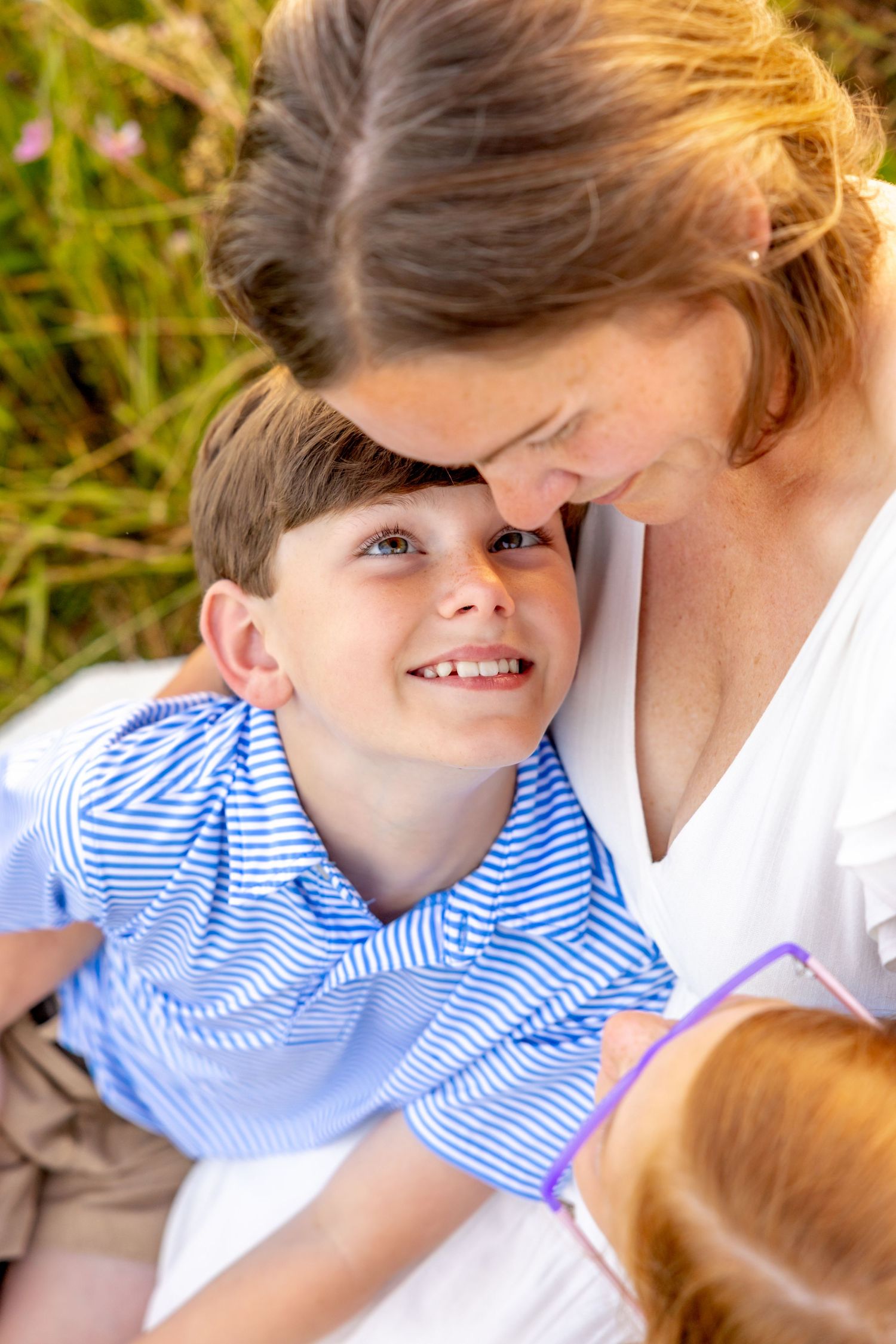 Sweet candid interactions between family members during golden hour photography session at Blue Hill Garden in Monroe, NC.