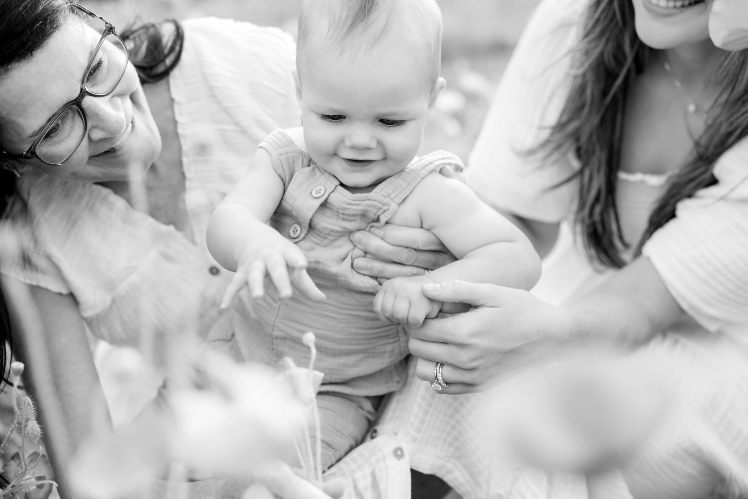 Black and white portrait of tender moments shared between mother and infant in nature at Blue Hill Garden in Monroe, NC.