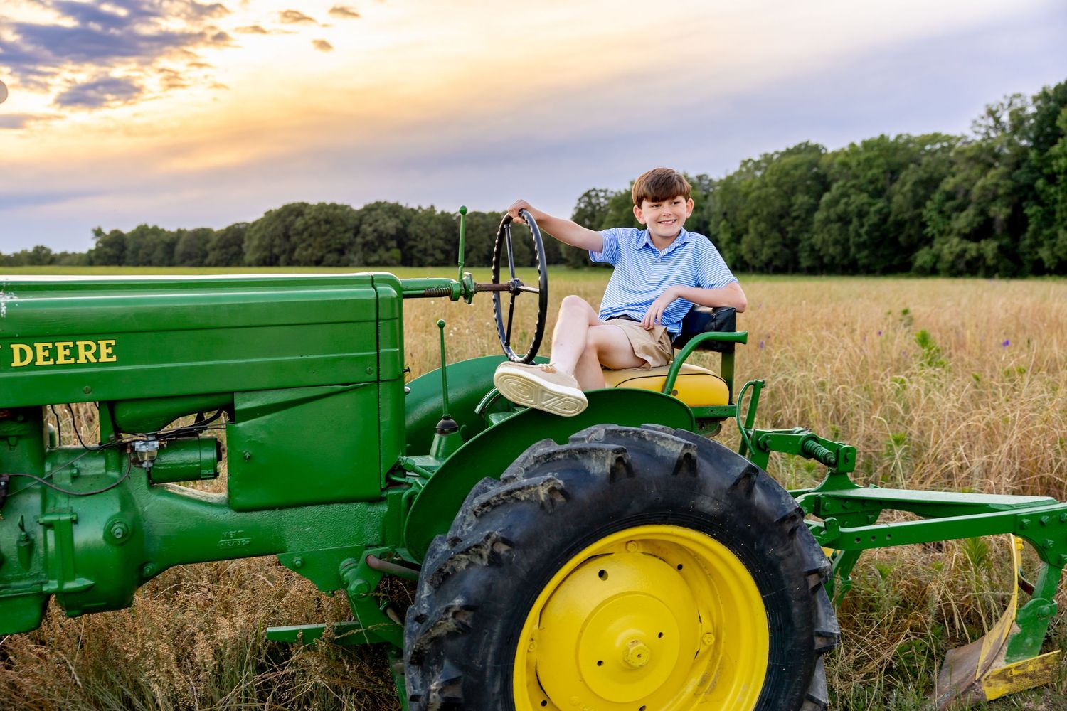 Classic John Deere tractor photographed in a wheat field at golden hour at Blue Hill Garden in Monroe, NC.