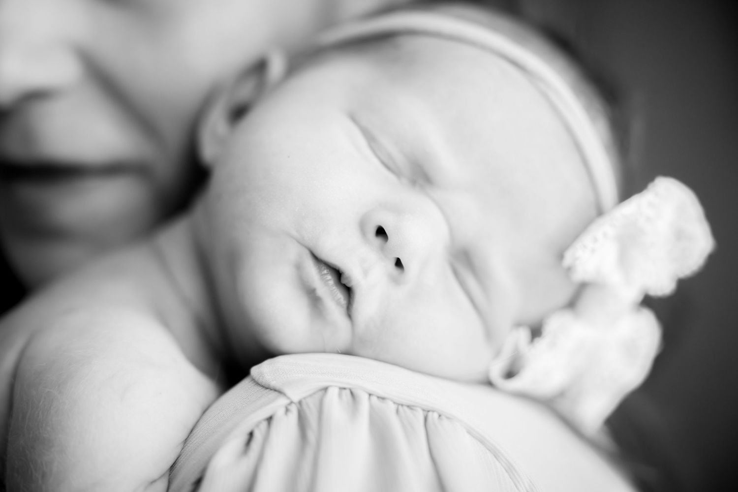 Intimate black and white portrait with dramatic lighting and shallow depth of field.