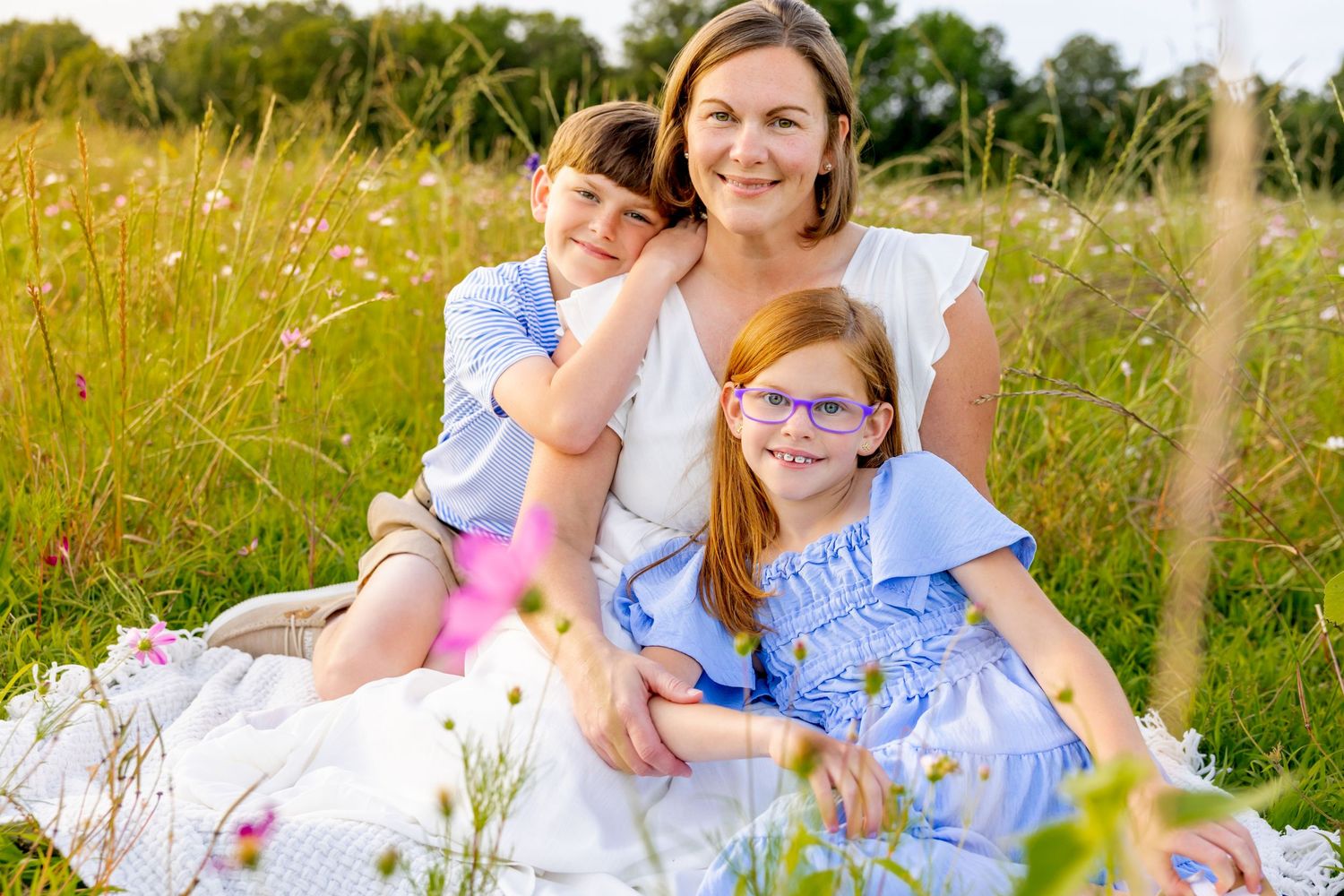 Family photography session in a golden meadow filled with summer wildflowers at Blue Hill Garden in Monroe, NC.
